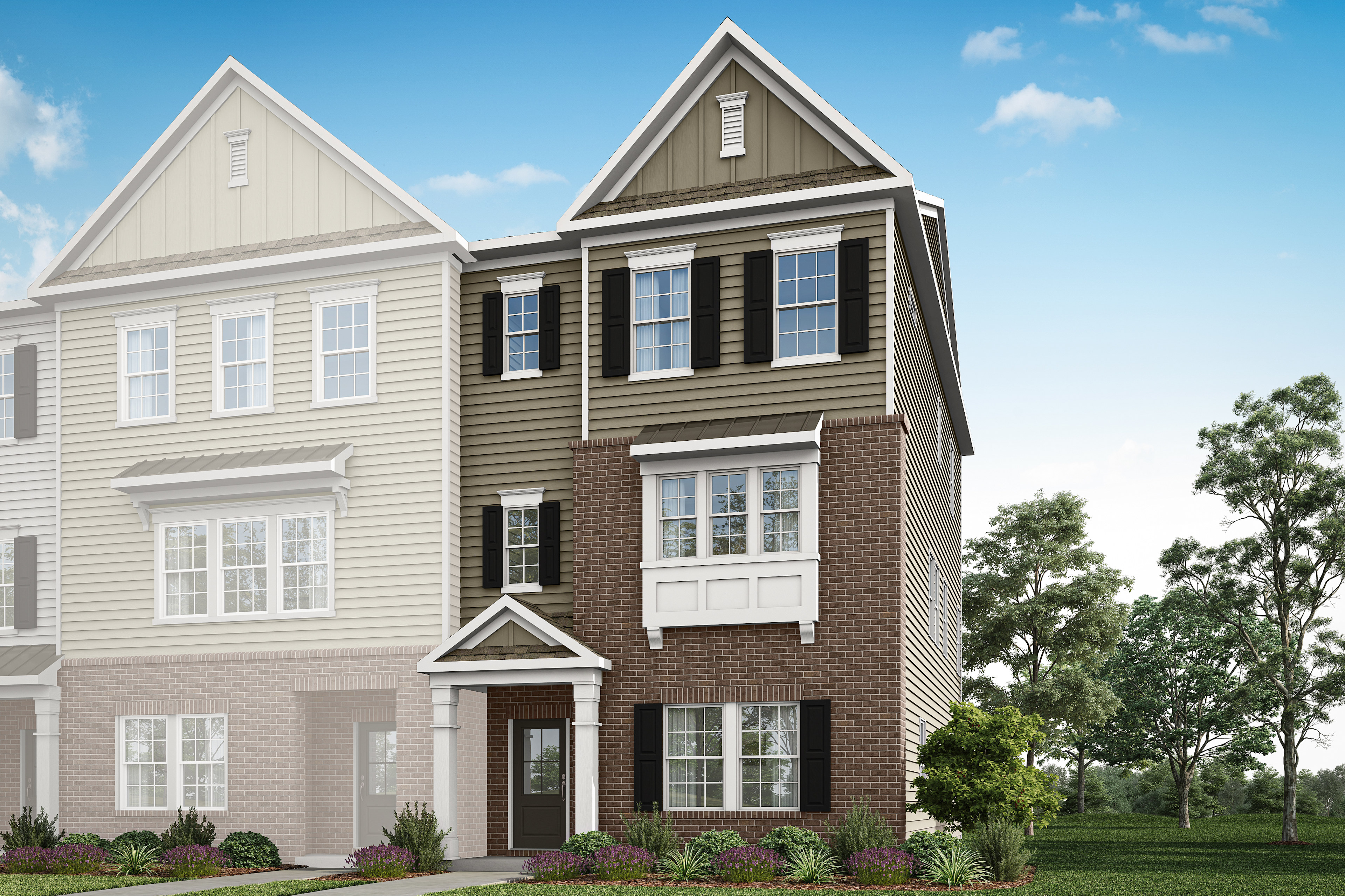A two-story townhouse with a brick facade, white trim, and a gabled roof stands in a well-landscaped yard with trees in the background.