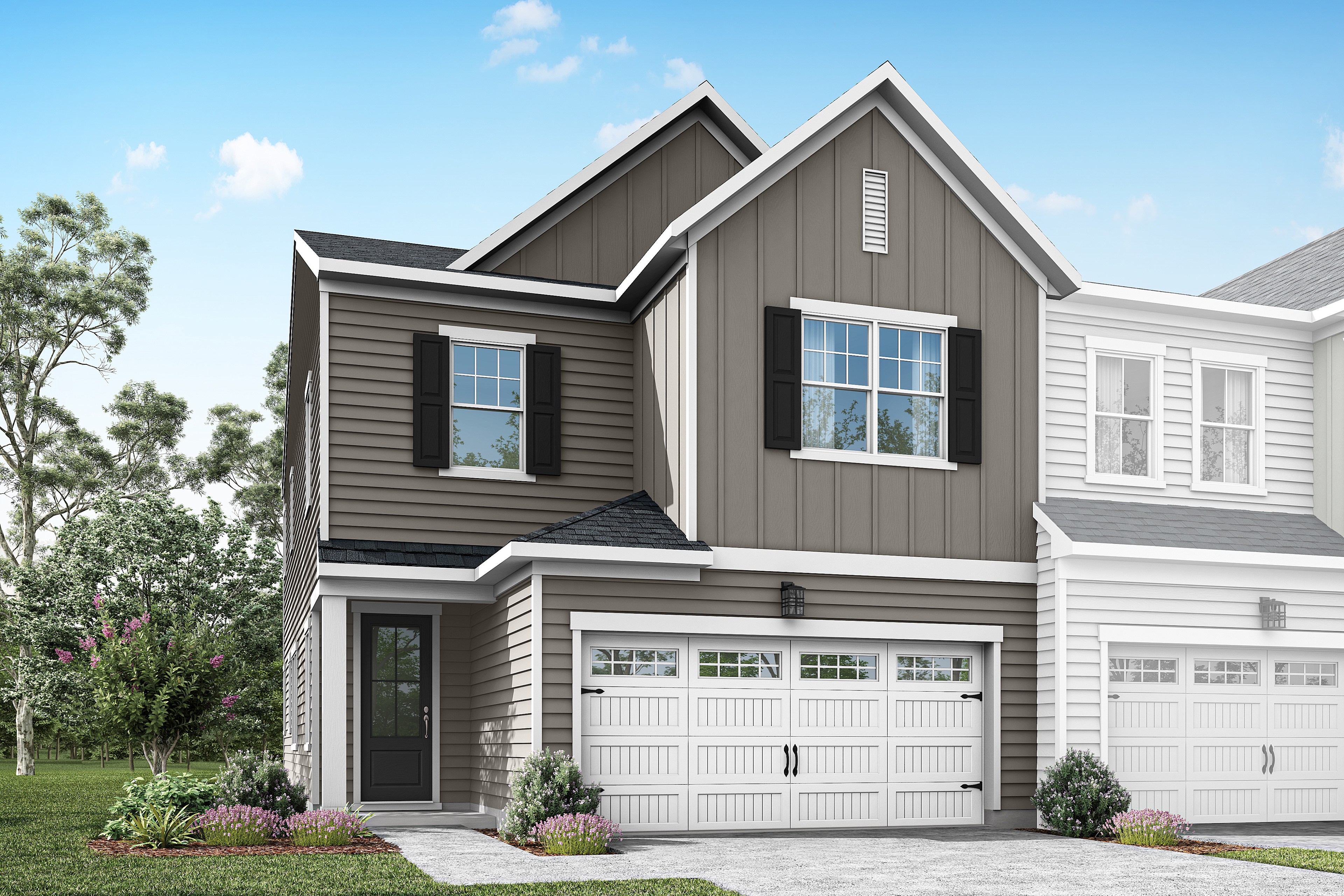 A two-story residential house with a gray exterior, white trim, and a double garage door sits in a grassy area with trees in the background under a blue sky with clouds.