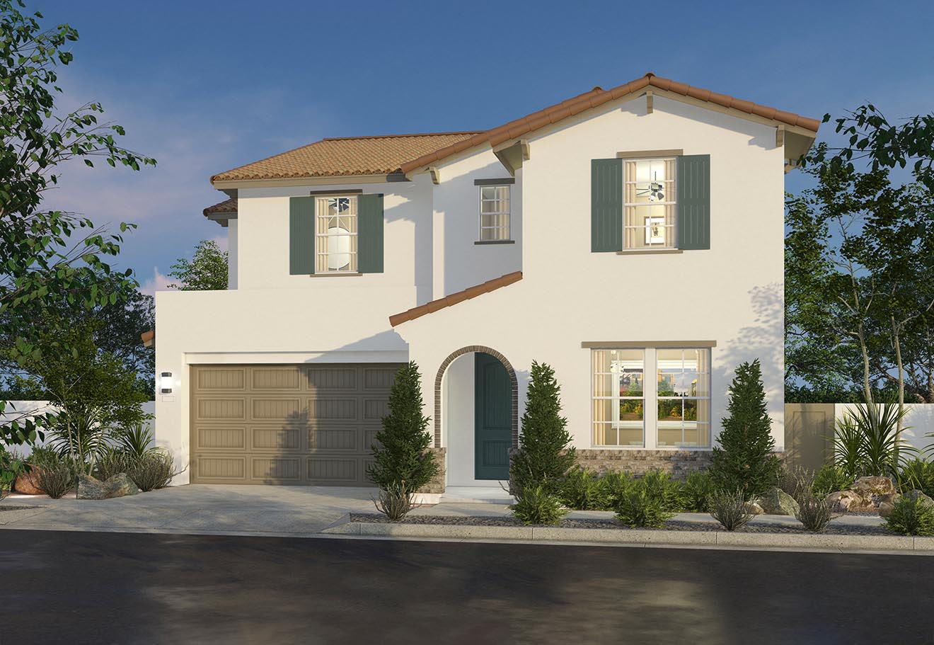 A two-story Mediterranean-style house with a white exterior, a tiled roof, and a garage door sits in a well-landscaped yard with trees and shrubs in the foreground.