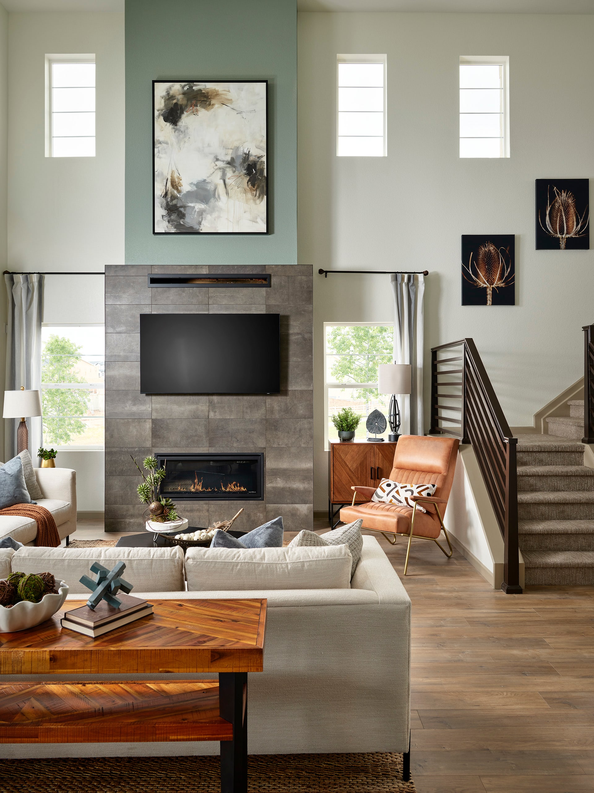 A cozy and inviting living room with a large fireplace, a comfortable sofa, and various decorative elements such as artwork and plants, creating a warm and harmonious atmosphere.
