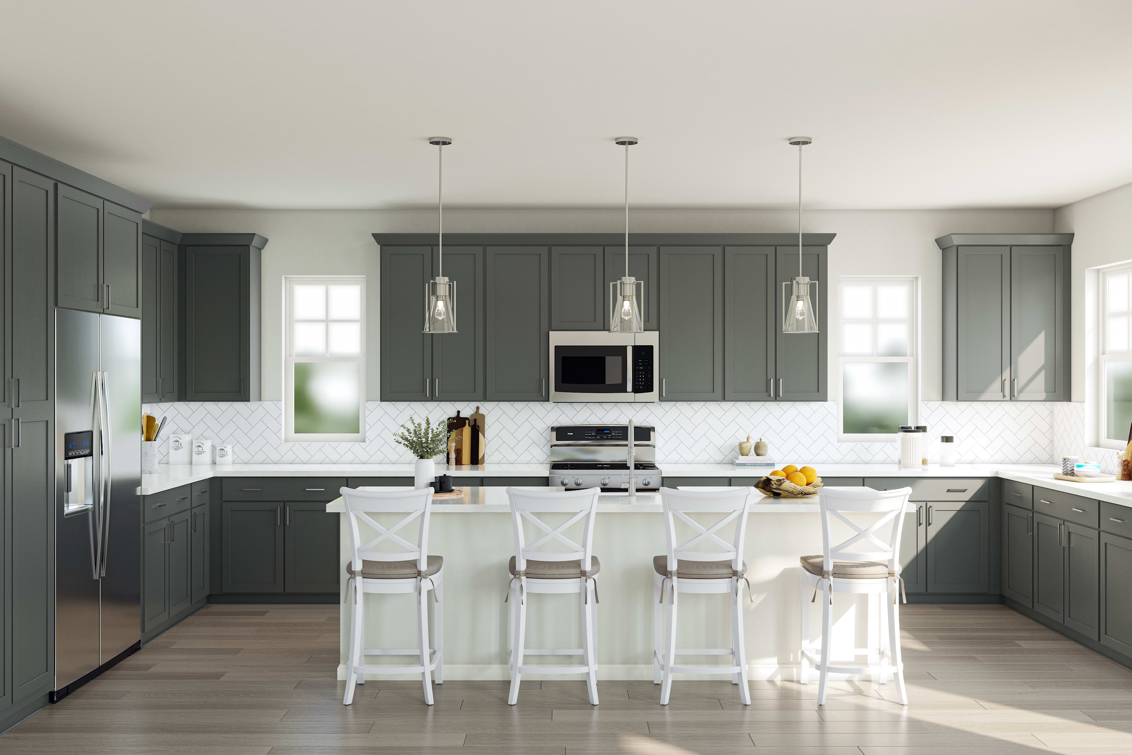 A modern, well-designed kitchen with gray cabinets, white countertops, and pendant lighting over a central island with stools.