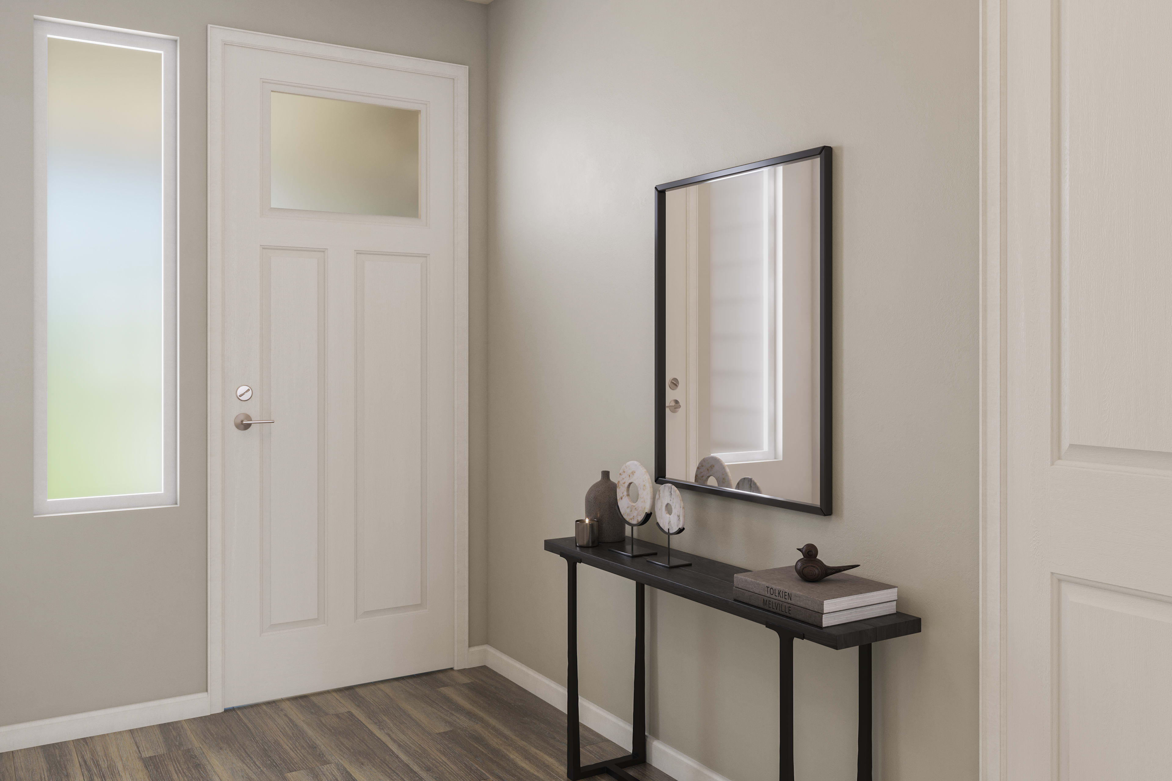 A modern and minimalist entryway with a wooden floor, a black console table, and a framed mirror on the wall.