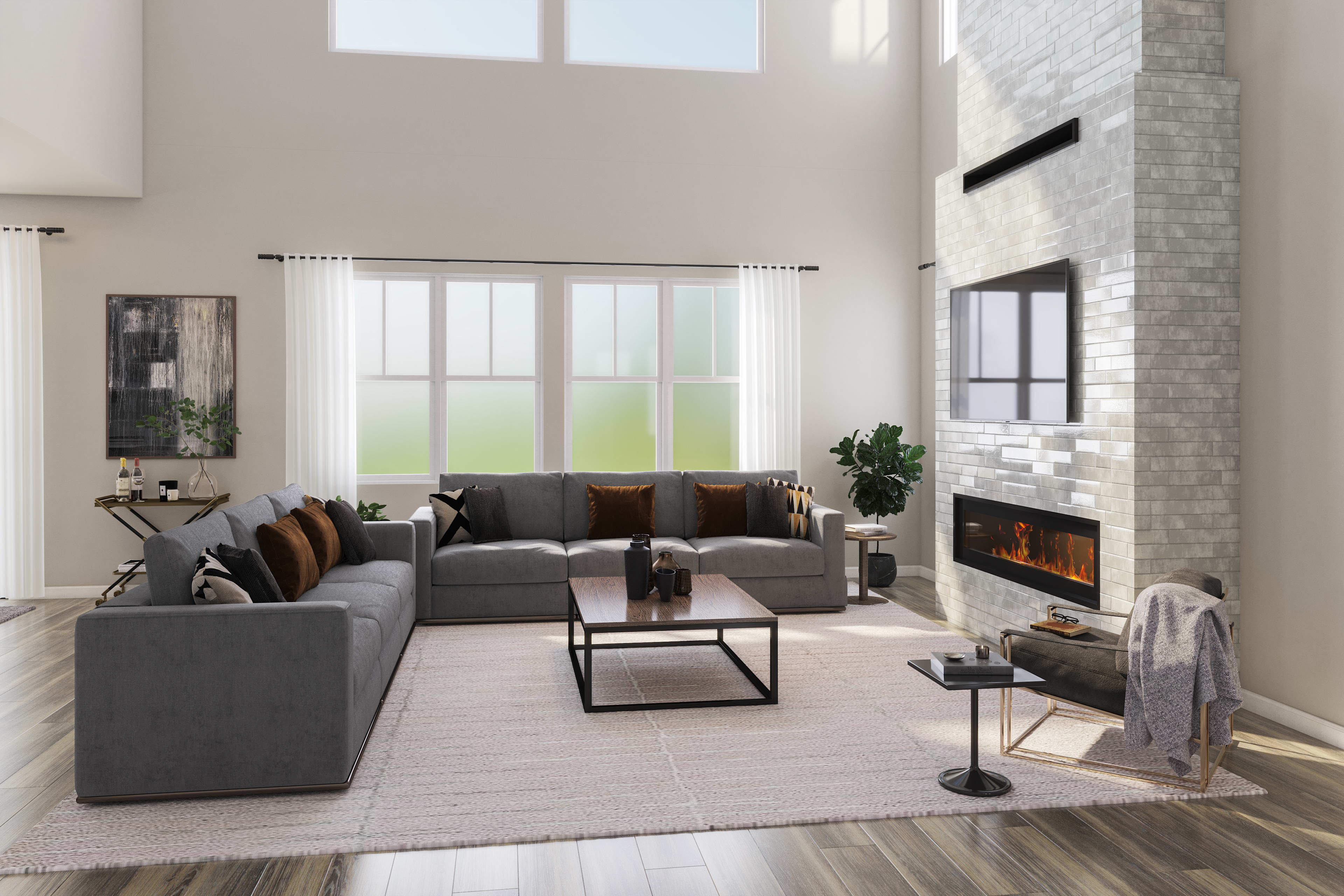 A spacious and modern living room with a large gray sectional sofa, a fireplace, and large windows overlooking a scenic outdoor view.
