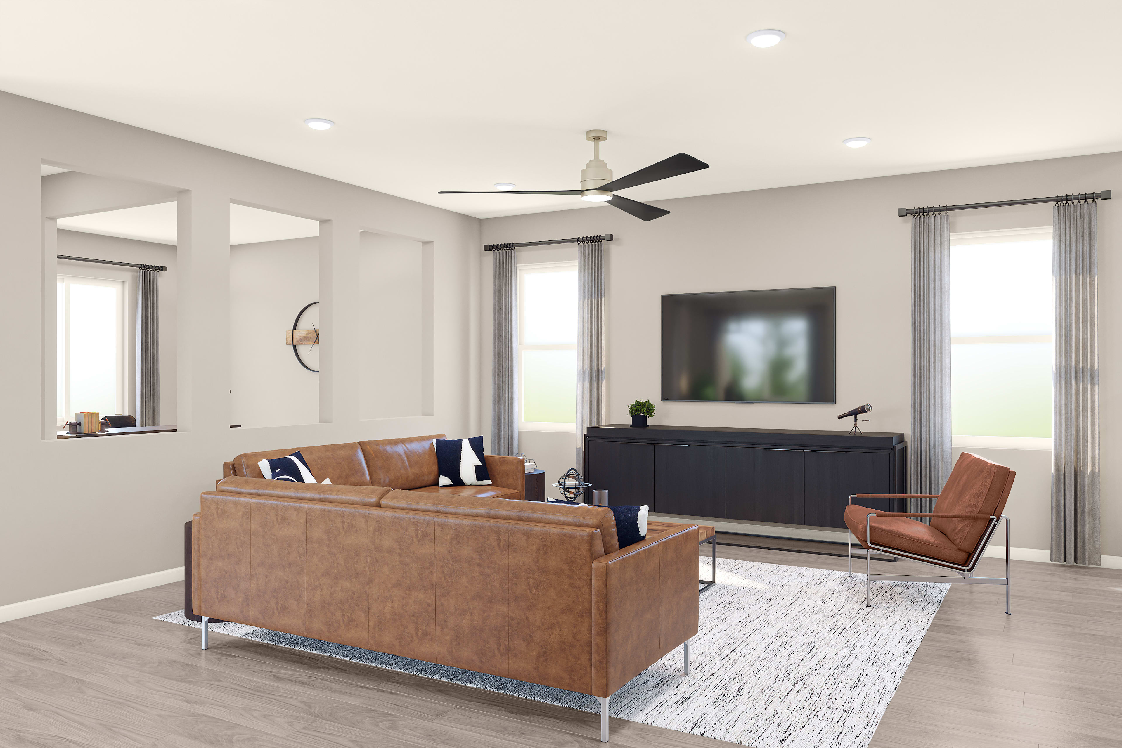 A modern and minimalist living room with a leather sofa, a TV stand, and a ceiling fan, set against a neutral color palette and large windows providing natural light.