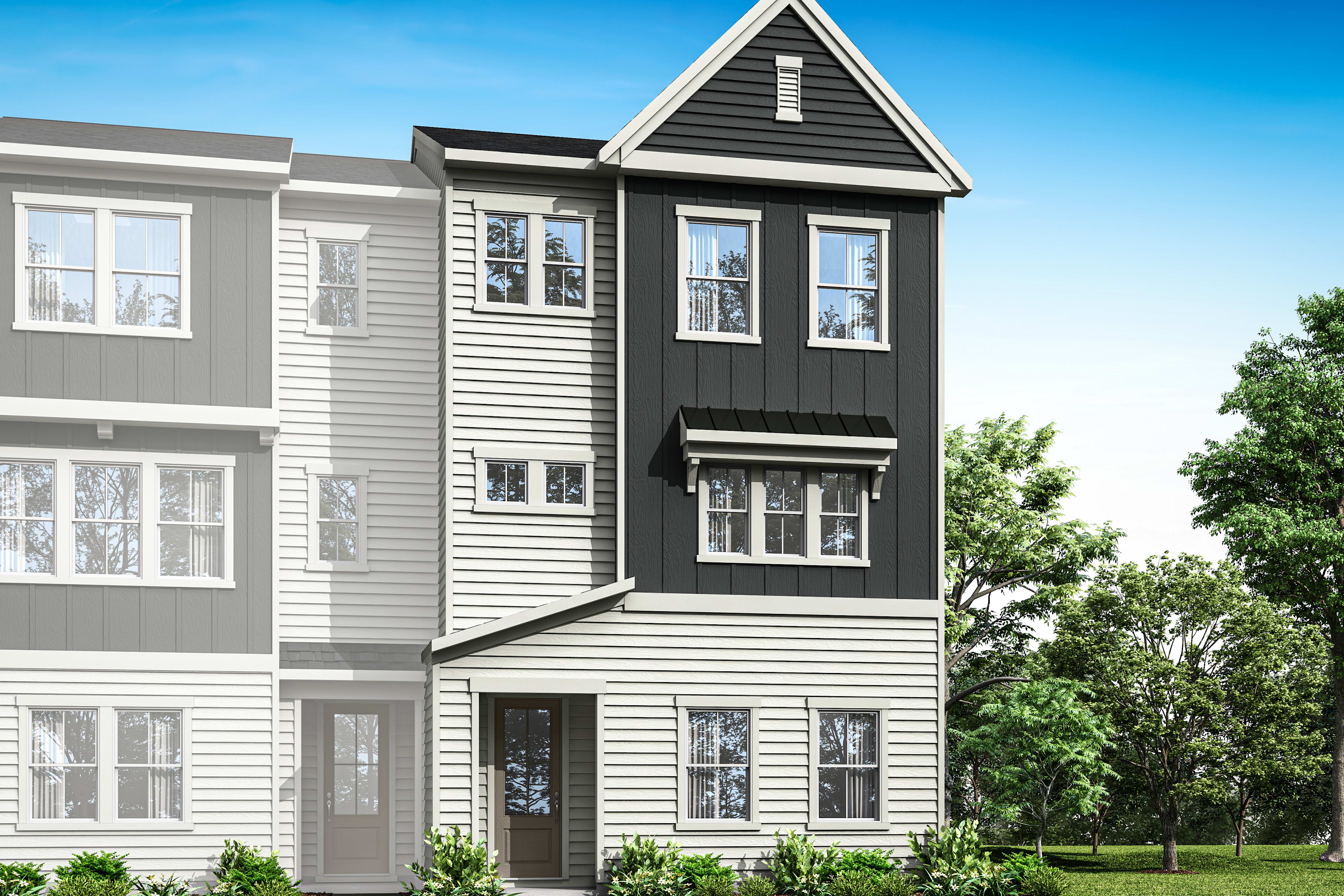 A modern, multi-story townhouse with gray siding and white trim, surrounded by lush greenery and a clear blue sky.