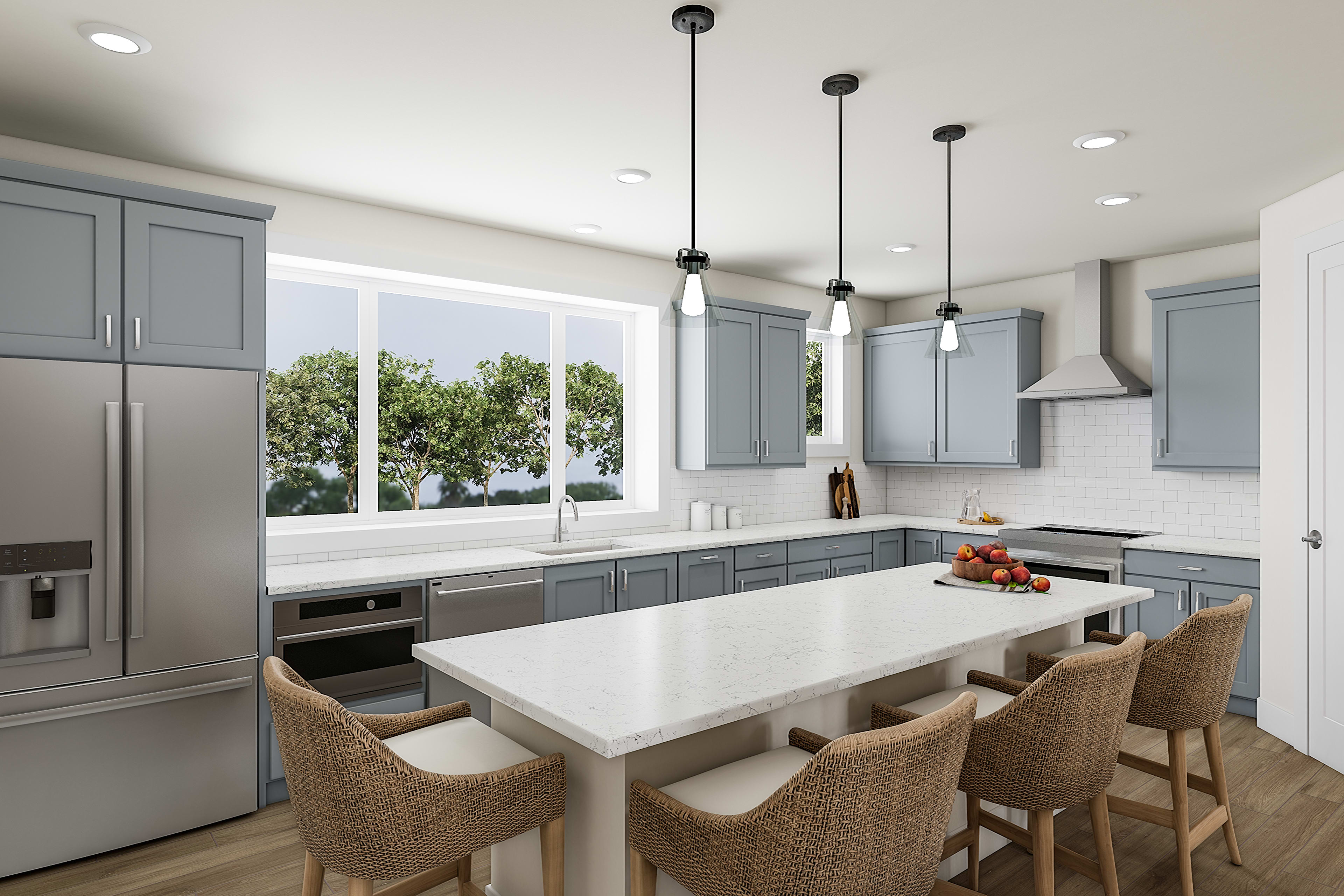 A modern, open-concept kitchen with gray cabinets, white countertops, and pendant lighting over a wooden dining table with wicker chairs.