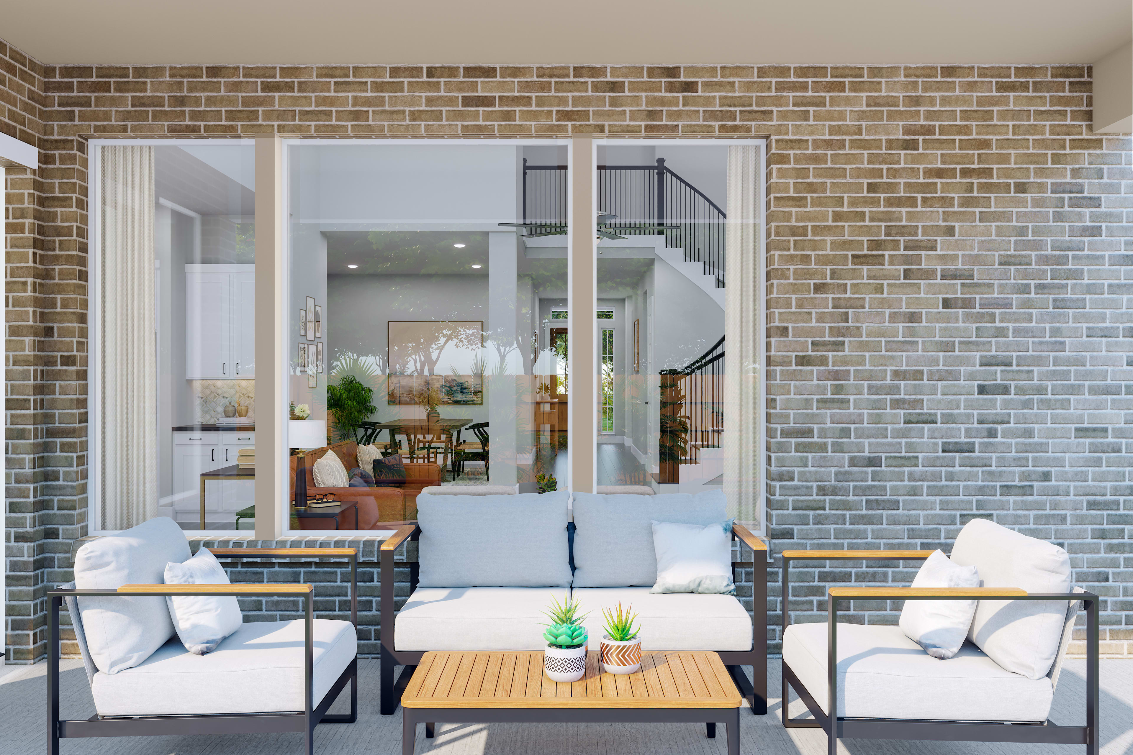 A cozy outdoor seating area with a sofa, chairs, and a coffee table, set against a backdrop of a brick wall and glass doors leading to the interior of the home.