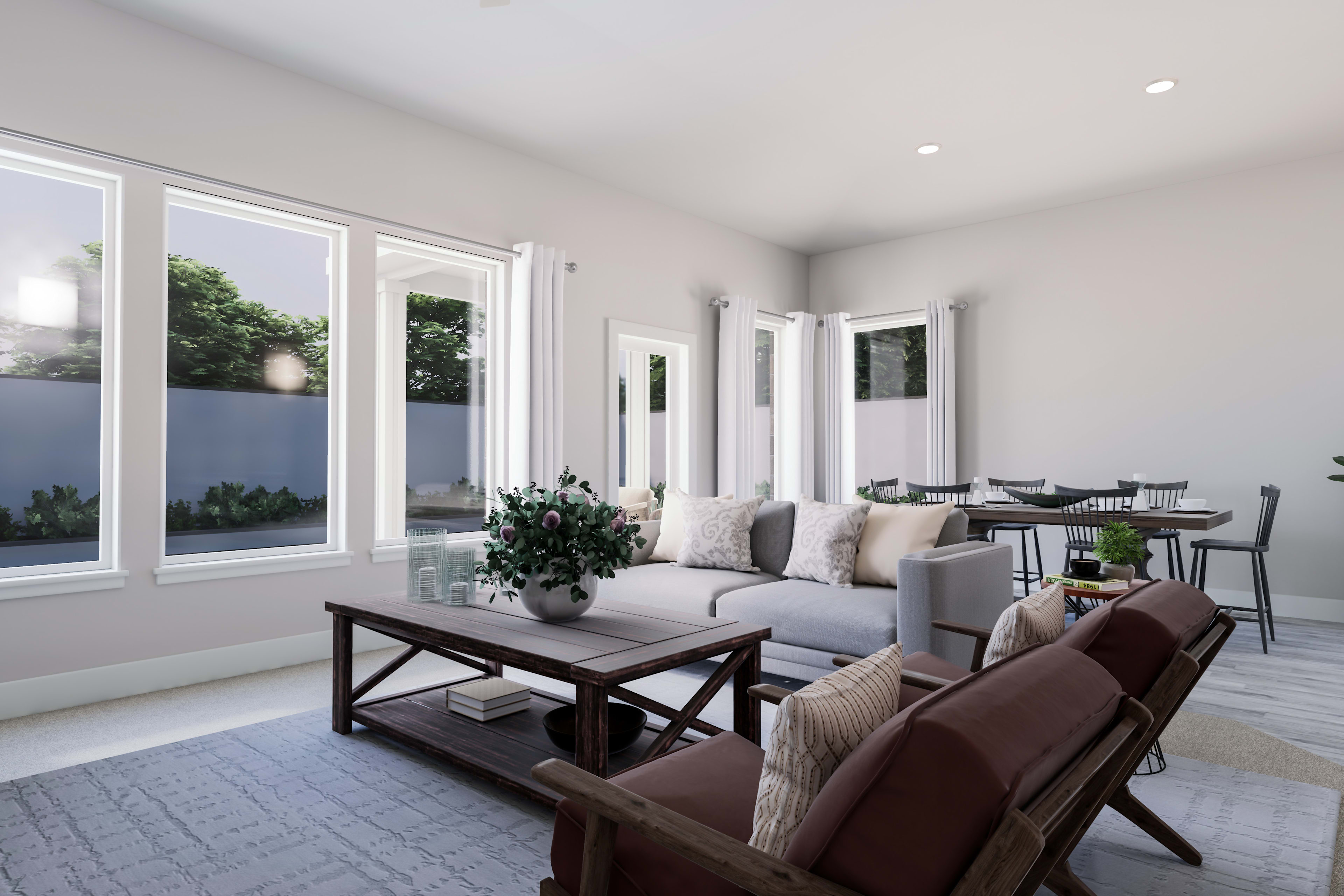 A modern and spacious living room with large windows overlooking a lush outdoor landscape, featuring a cozy seating area with plush furniture and decorative accents.