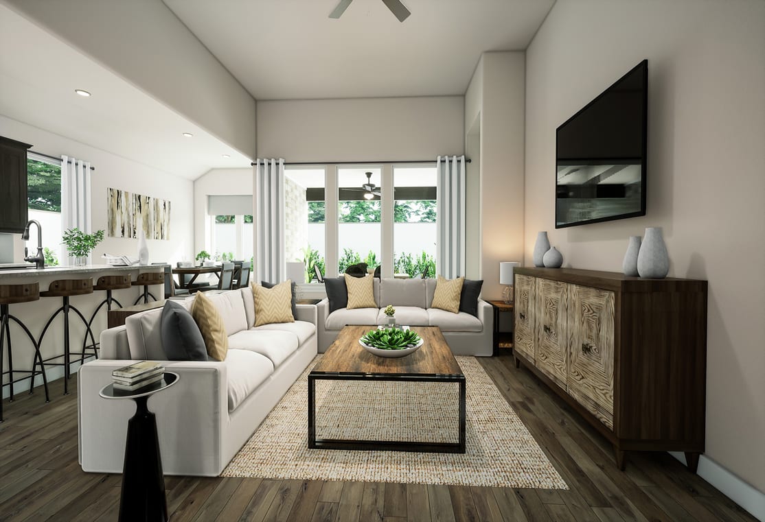 A cozy and modern living room with a white sofa, wooden furniture, and large windows overlooking greenery outside.