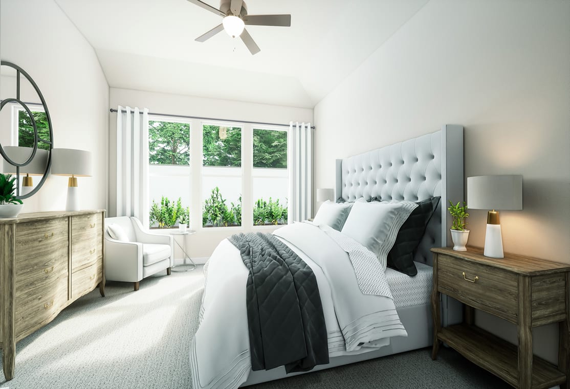A cozy and well-designed bedroom with a large window overlooking lush greenery, featuring a plush bed, wooden furniture, and decorative accents that create a serene and inviting atmosphere.