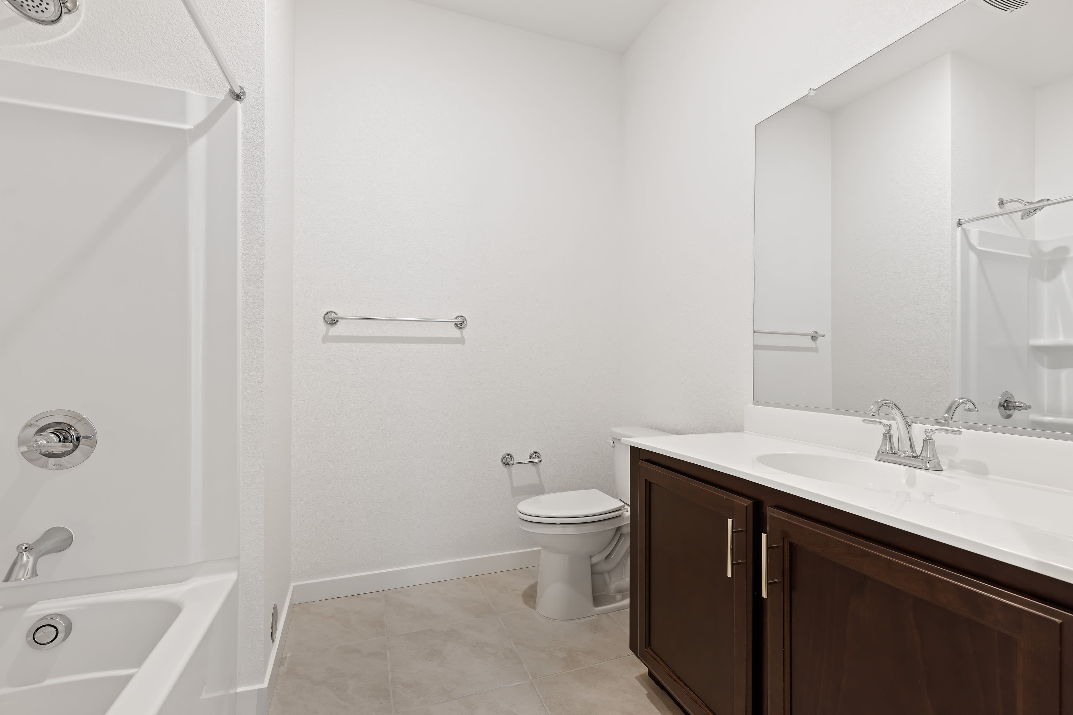 A modern and clean bathroom with a vanity cabinet, toilet, and shower visible in the image.