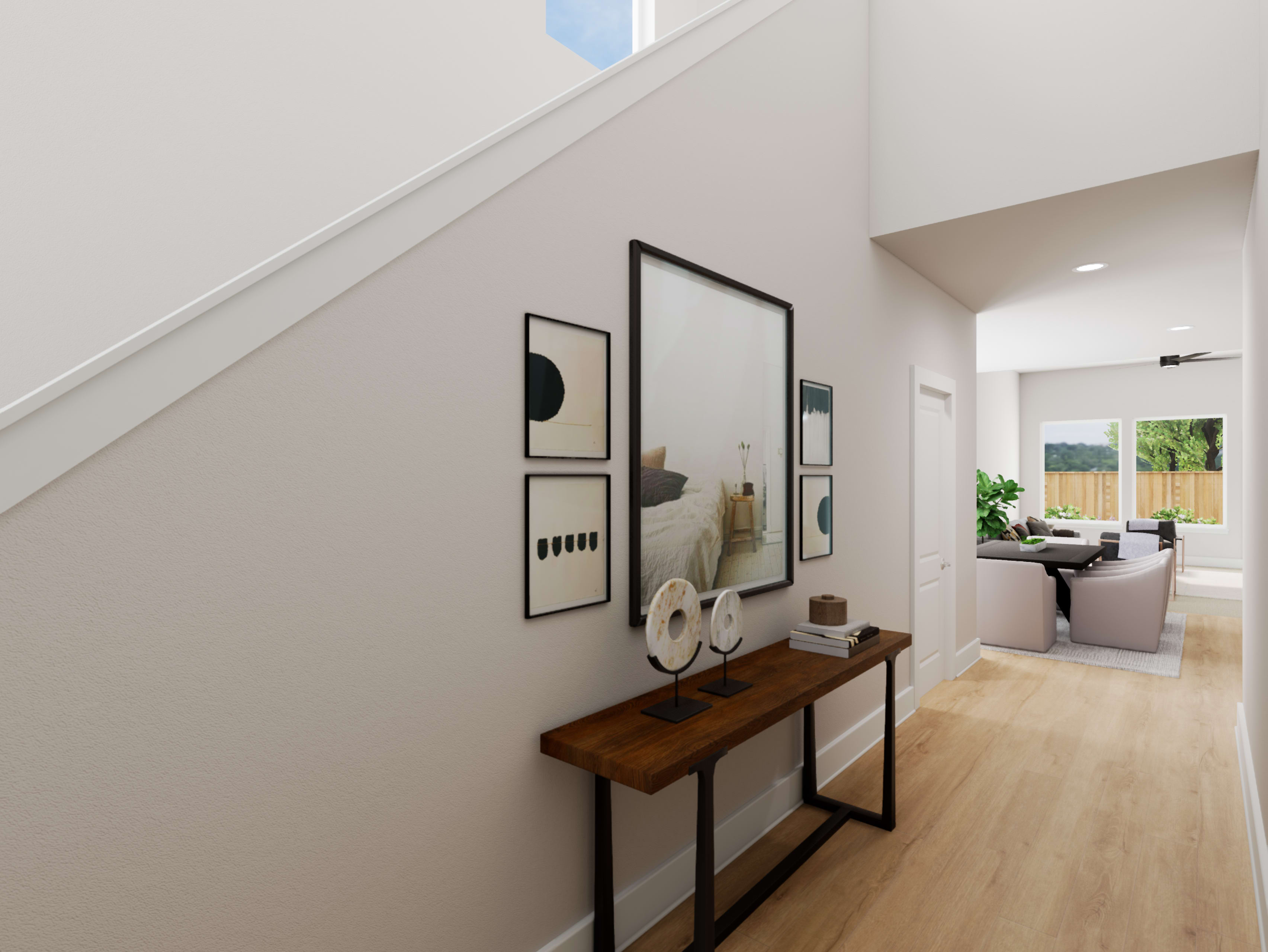 A modern and minimalist entryway with a wooden console table, framed artwork, and a view of an adjacent room with natural lighting.