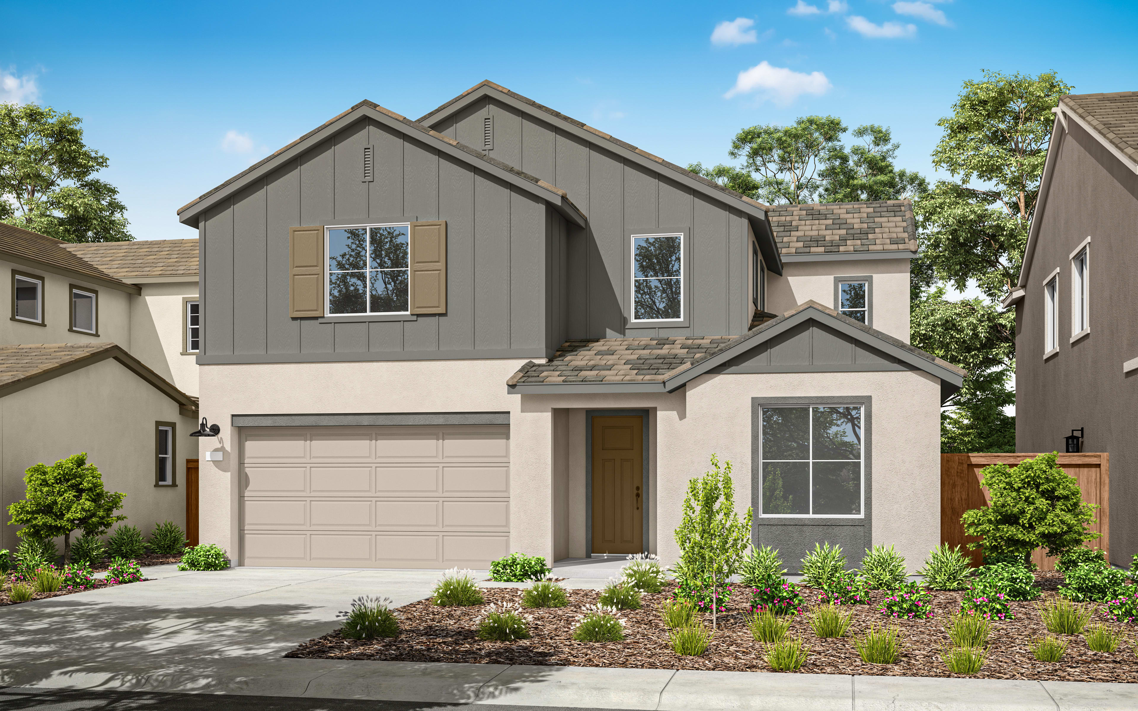 A two-story gray house with a garage, surrounded by lush greenery and a clear blue sky in the background.