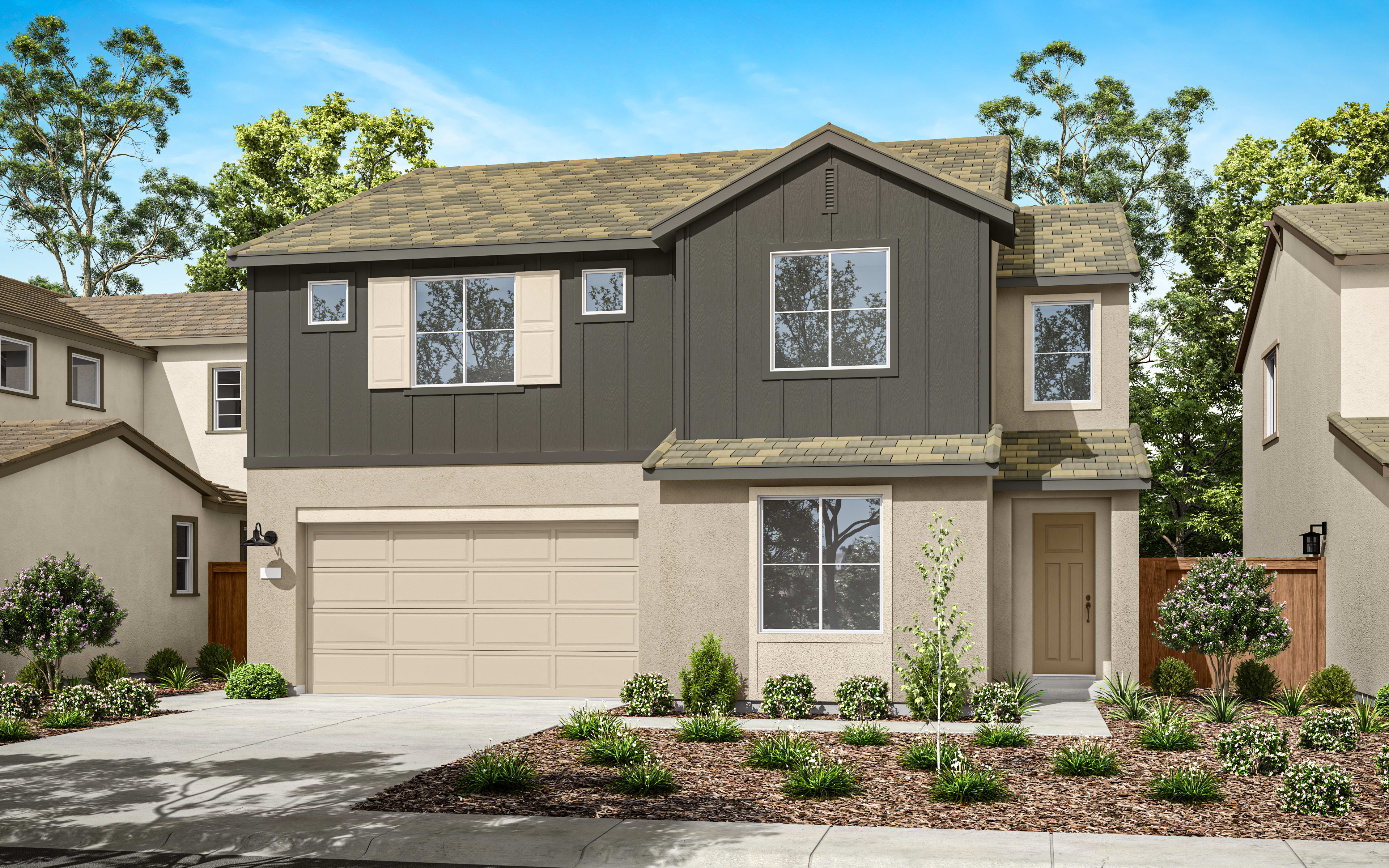 A two-story residential house with a garage, surrounded by lush greenery and a paved driveway in the foreground.