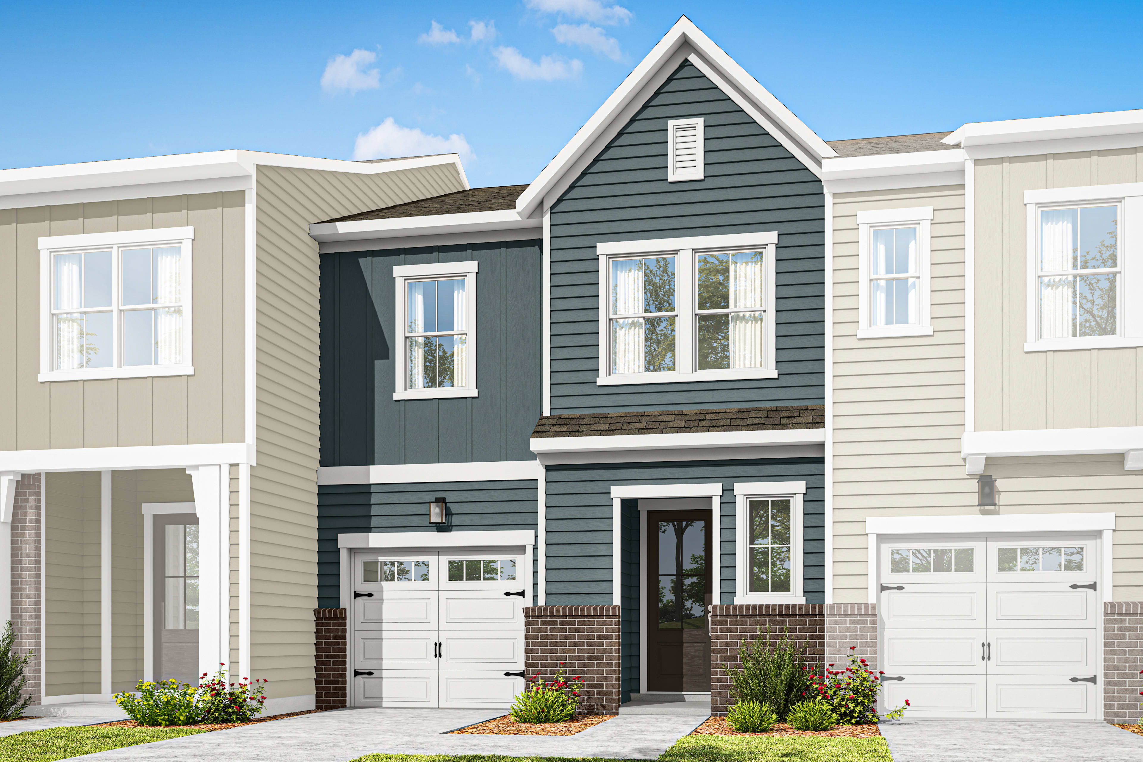 A two-story townhouse with a gray exterior, white trim, and a brick foundation sits in a well-manicured yard against a clear blue sky with scattered clouds.