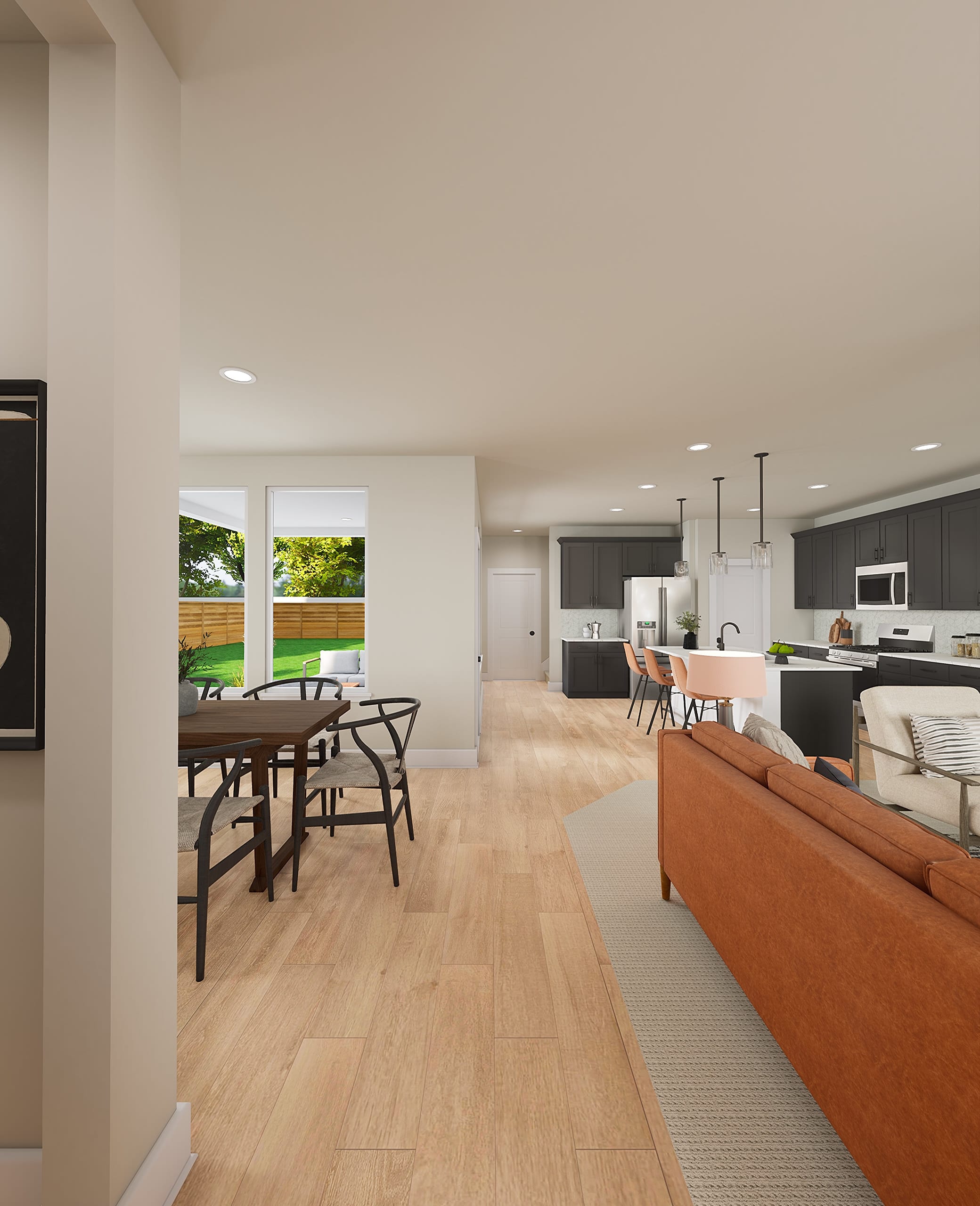 A modern and open-concept living space with a dining area, kitchen, and living room visible, featuring hardwood floors, large windows, and a cozy atmosphere.