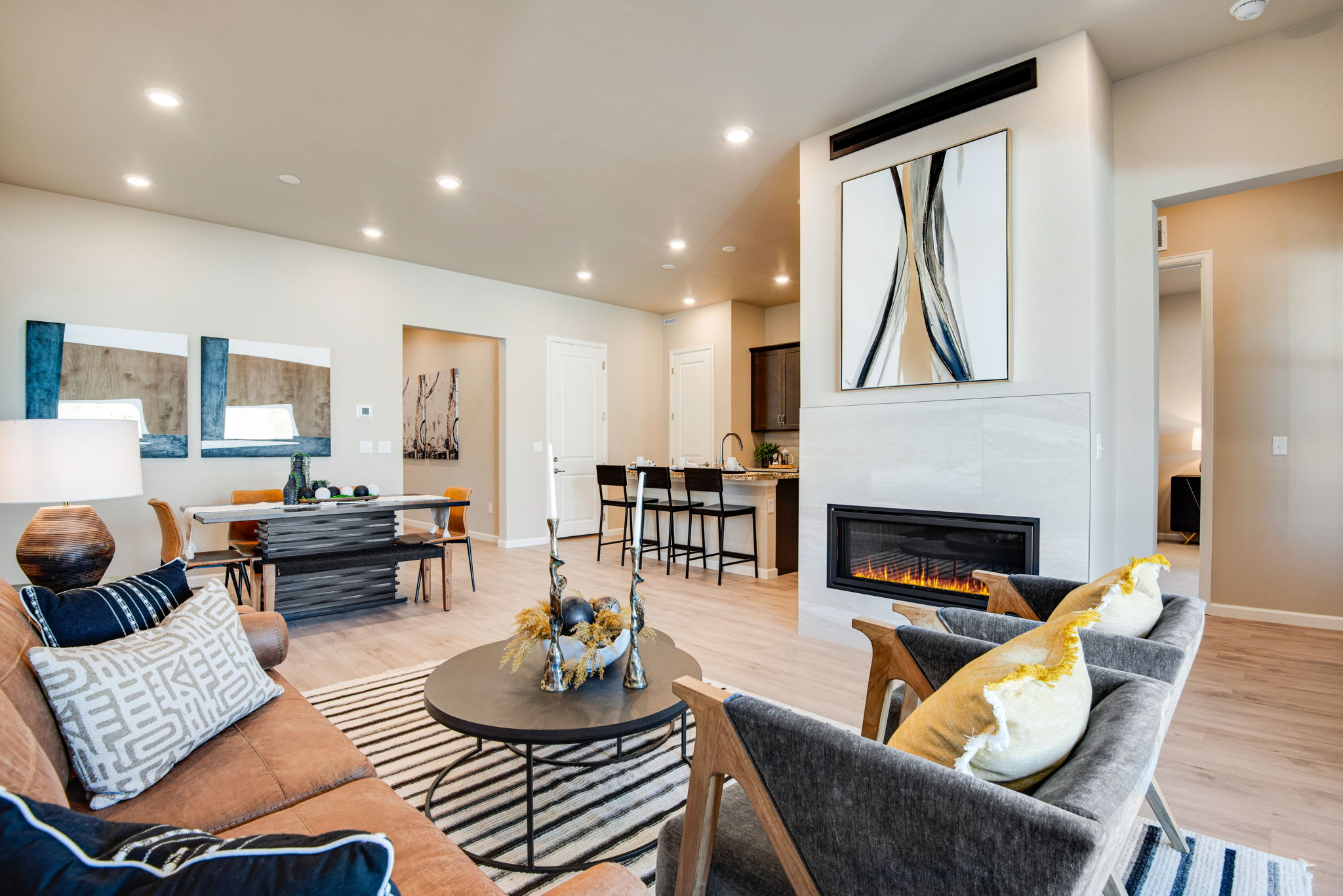 A modern and stylish living room with a fireplace, comfortable seating, and various decorative elements creating a warm and inviting atmosphere.