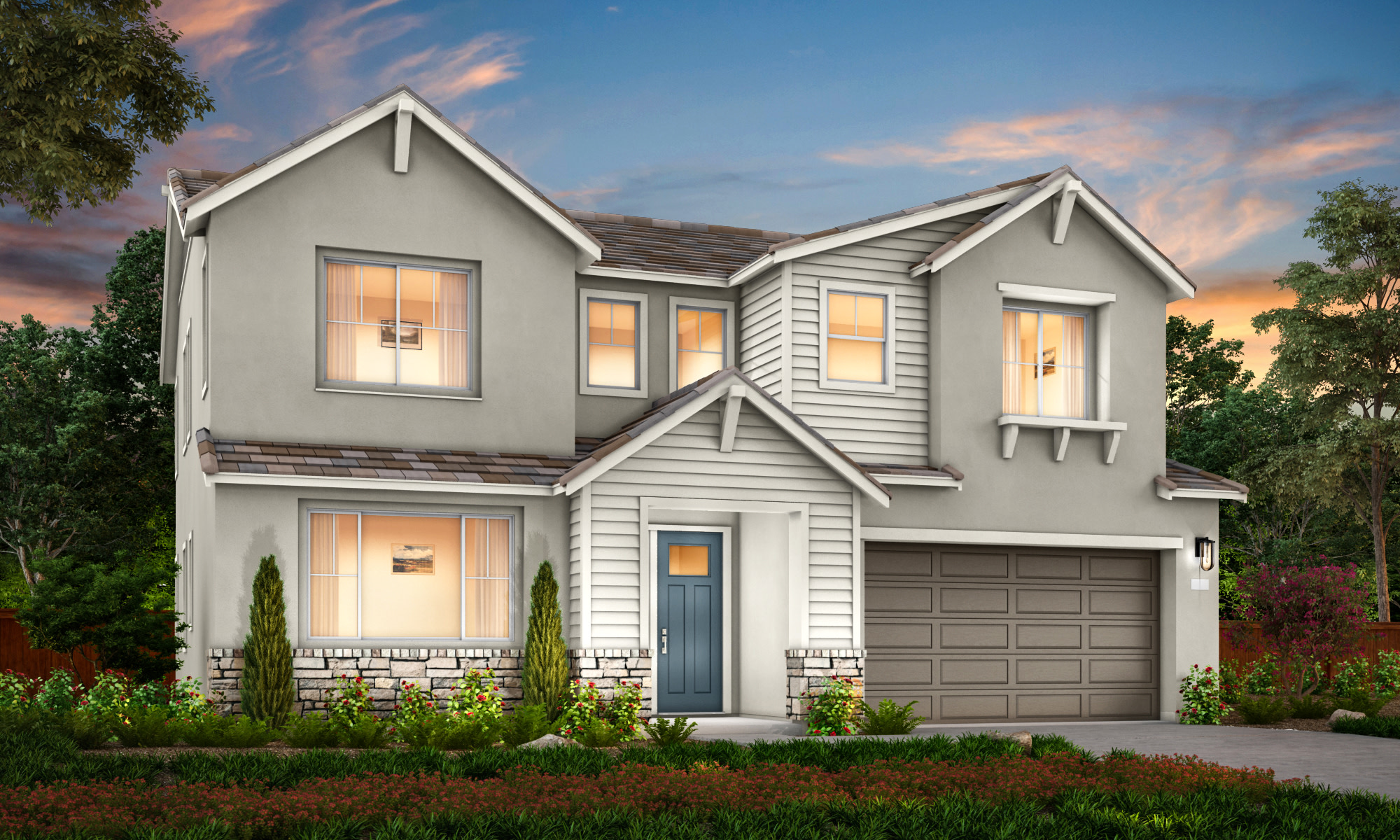 A two-story gray house with a garage, surrounded by landscaping and set against a colorful sunset sky.