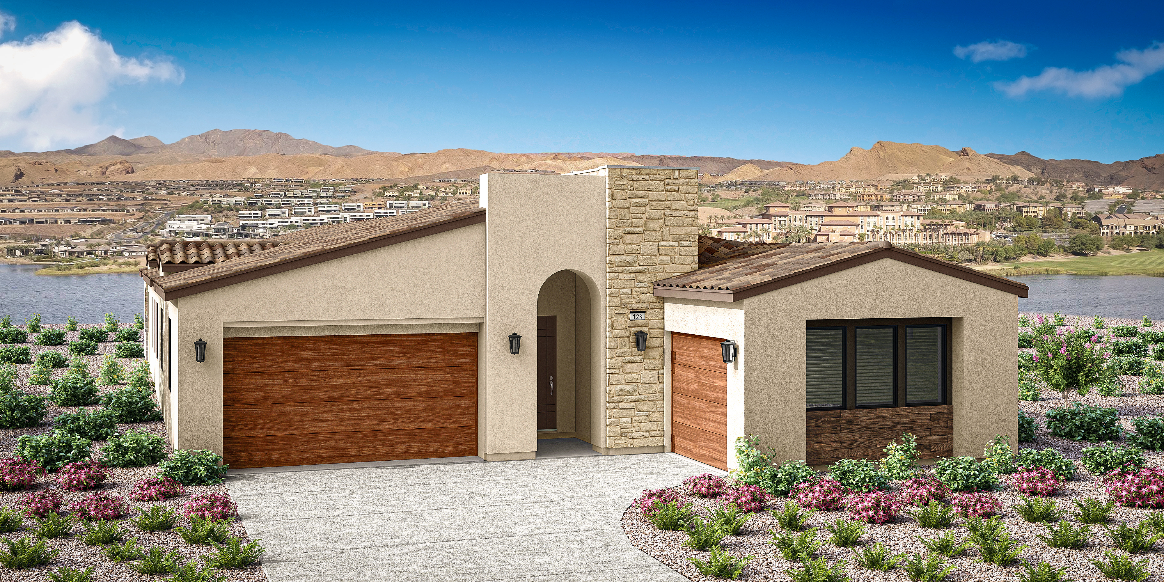 The image depicts a modern, two-story residential building with a wooden garage door and a small garden in the foreground. In the background, a mountainous landscape can be seen under a clear blue sky.