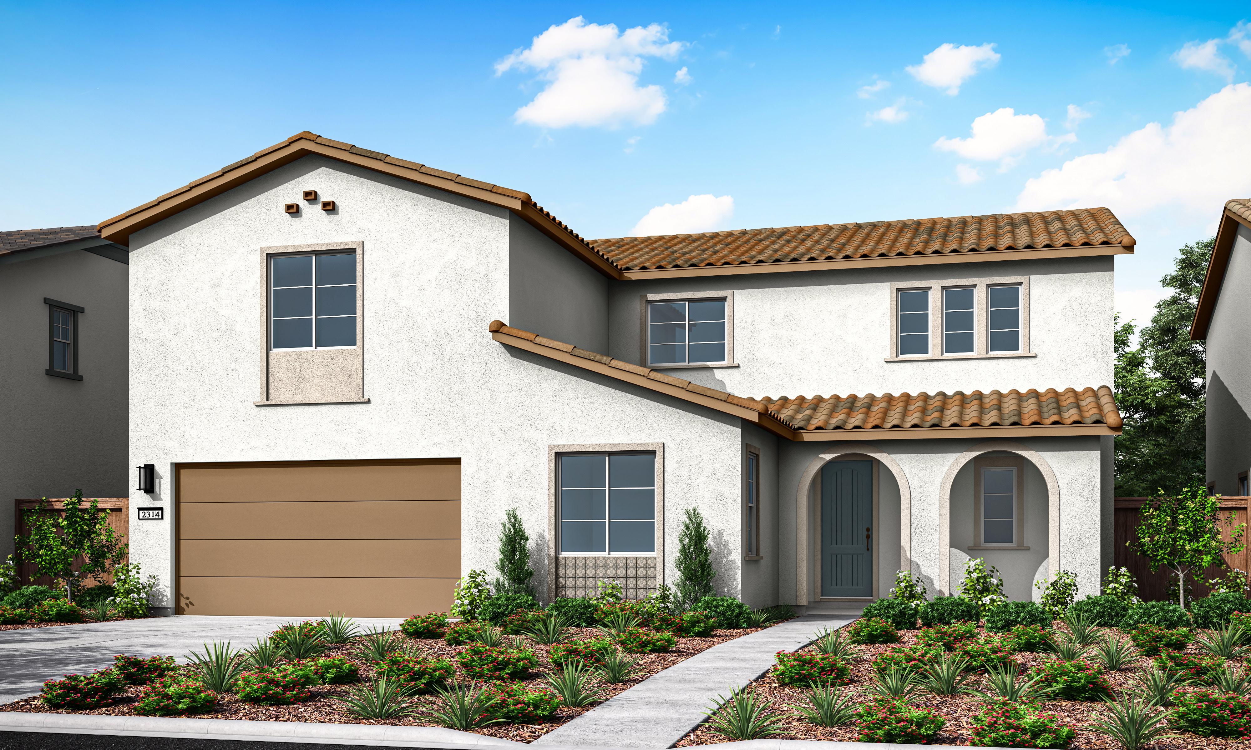 A two-story Mediterranean-style house with a tiled roof, a garage, and a well-landscaped front yard featuring various plants and shrubs against a backdrop of a blue sky with fluffy white clouds.