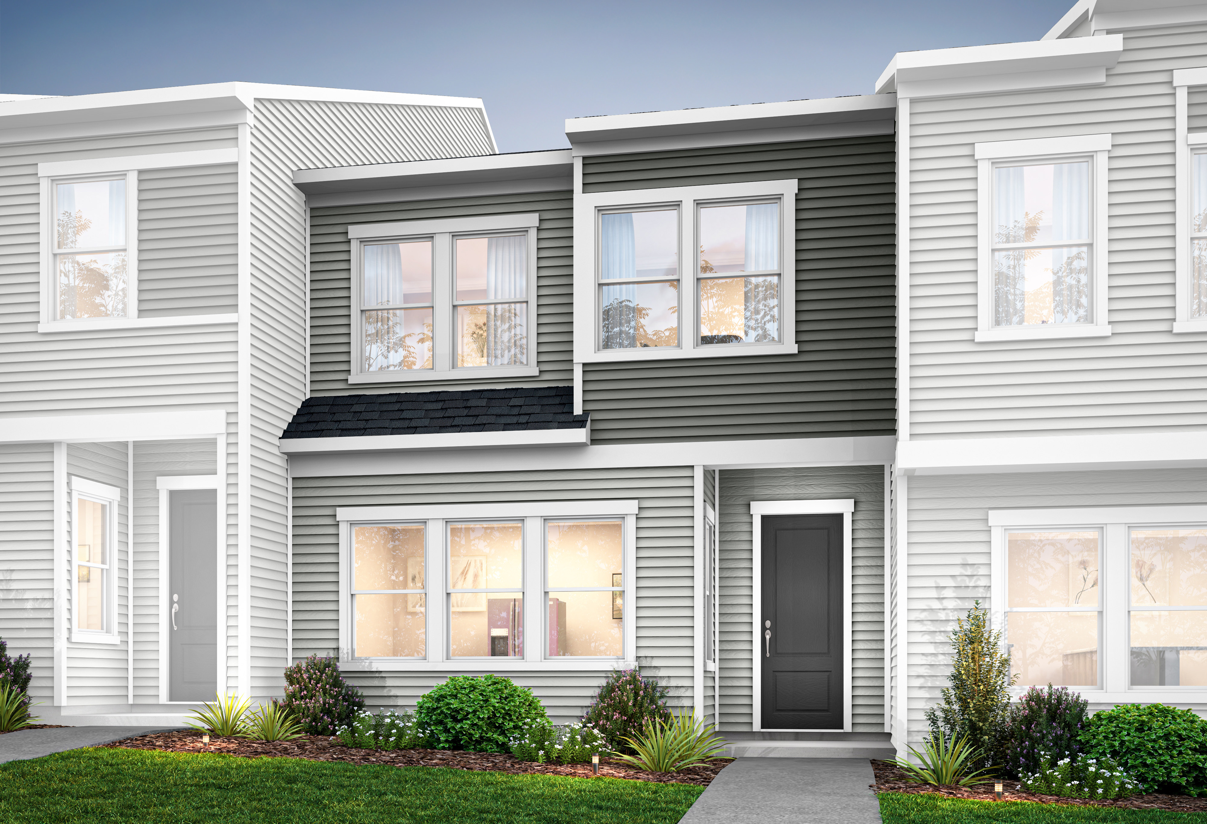 The image depicts a modern, multi-unit residential building with a clean, minimalist design featuring a mix of white and gray siding, large windows, and a well-landscaped front yard.