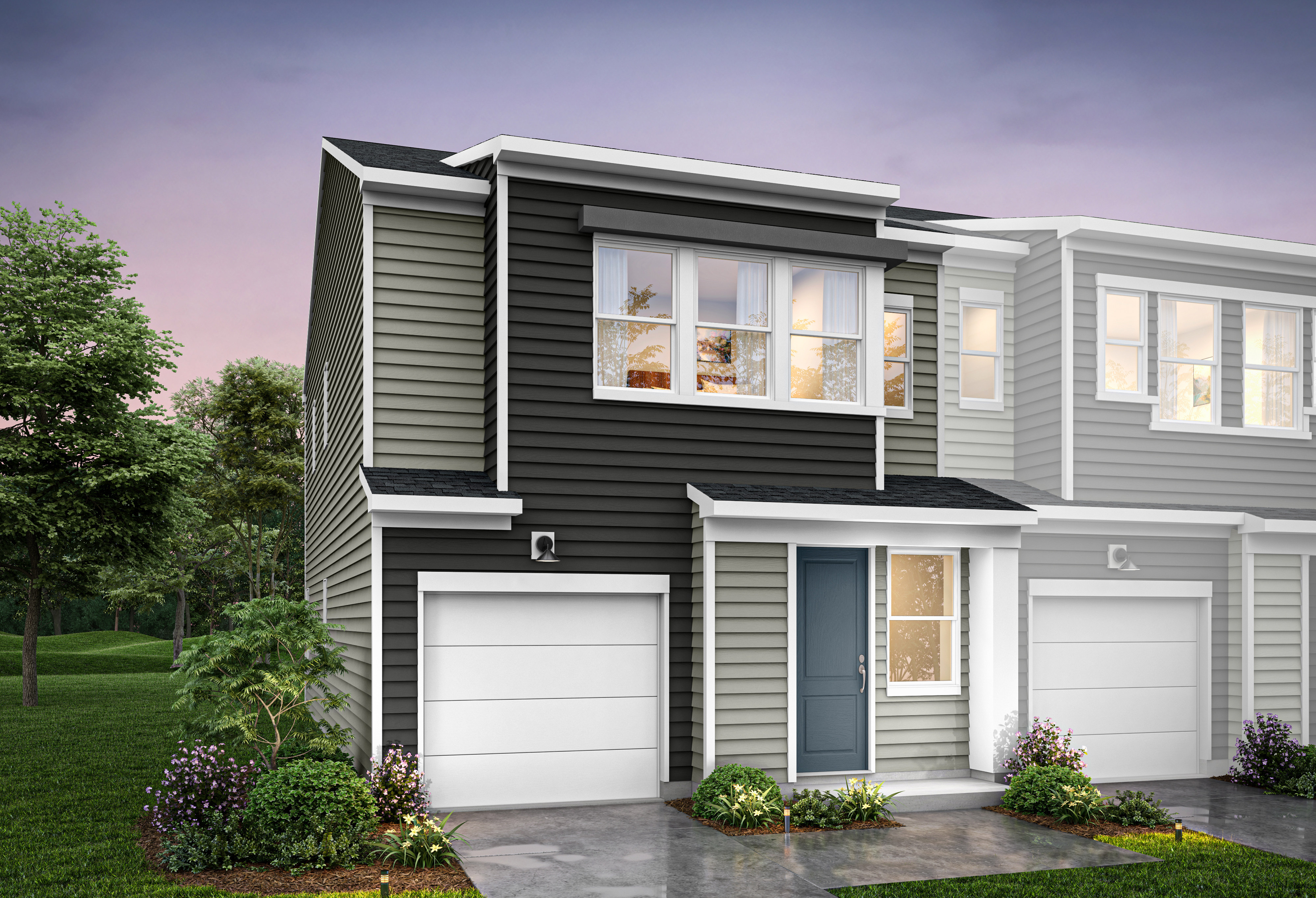 A modern two-story townhouse with a gray exterior, white trim, and a landscaped front yard featuring flowers and shrubs.