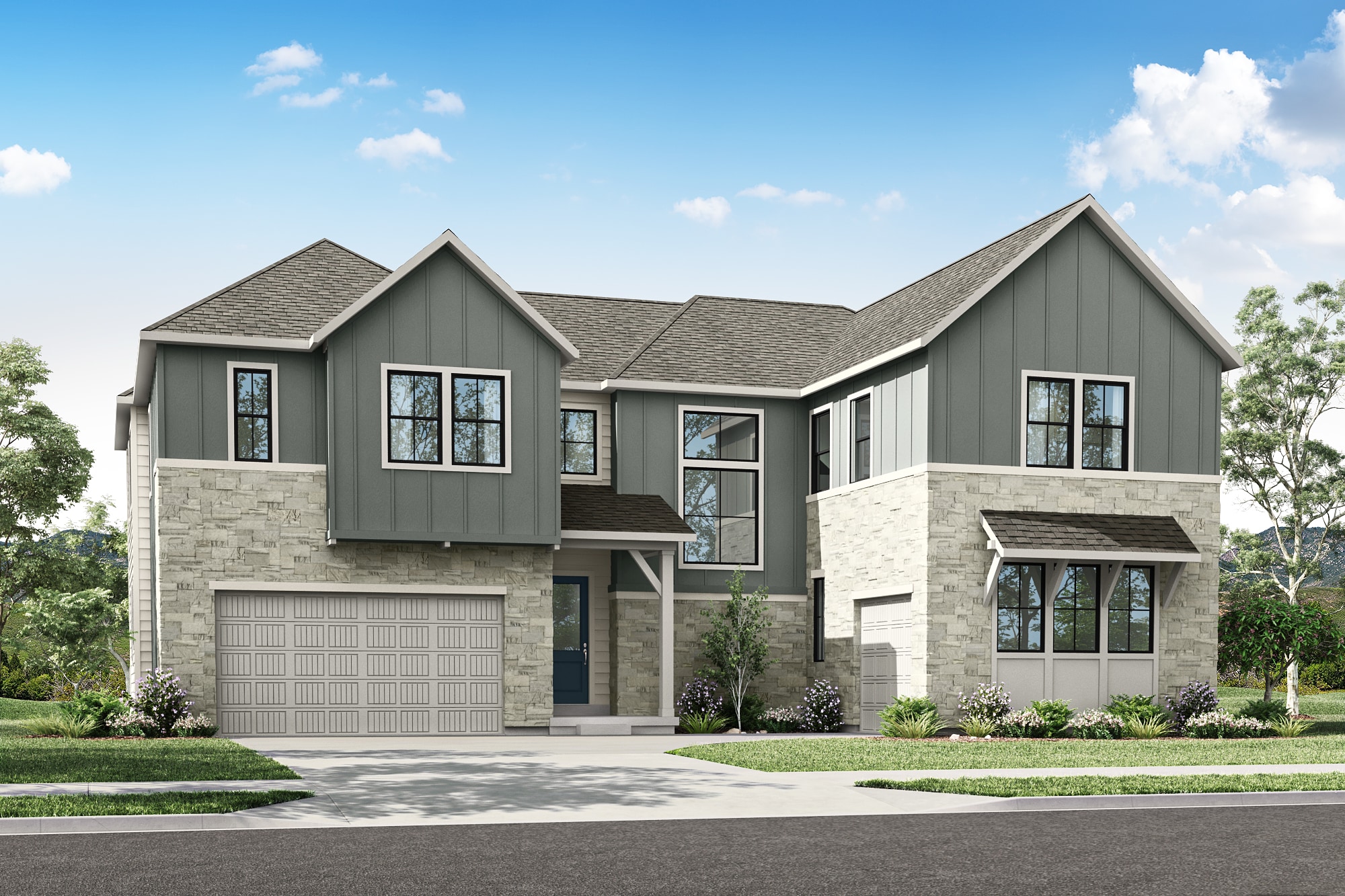 A two-story residential house with a gray exterior, a stone facade, and a garage door stands in a well-landscaped yard with trees and shrubs in the background.