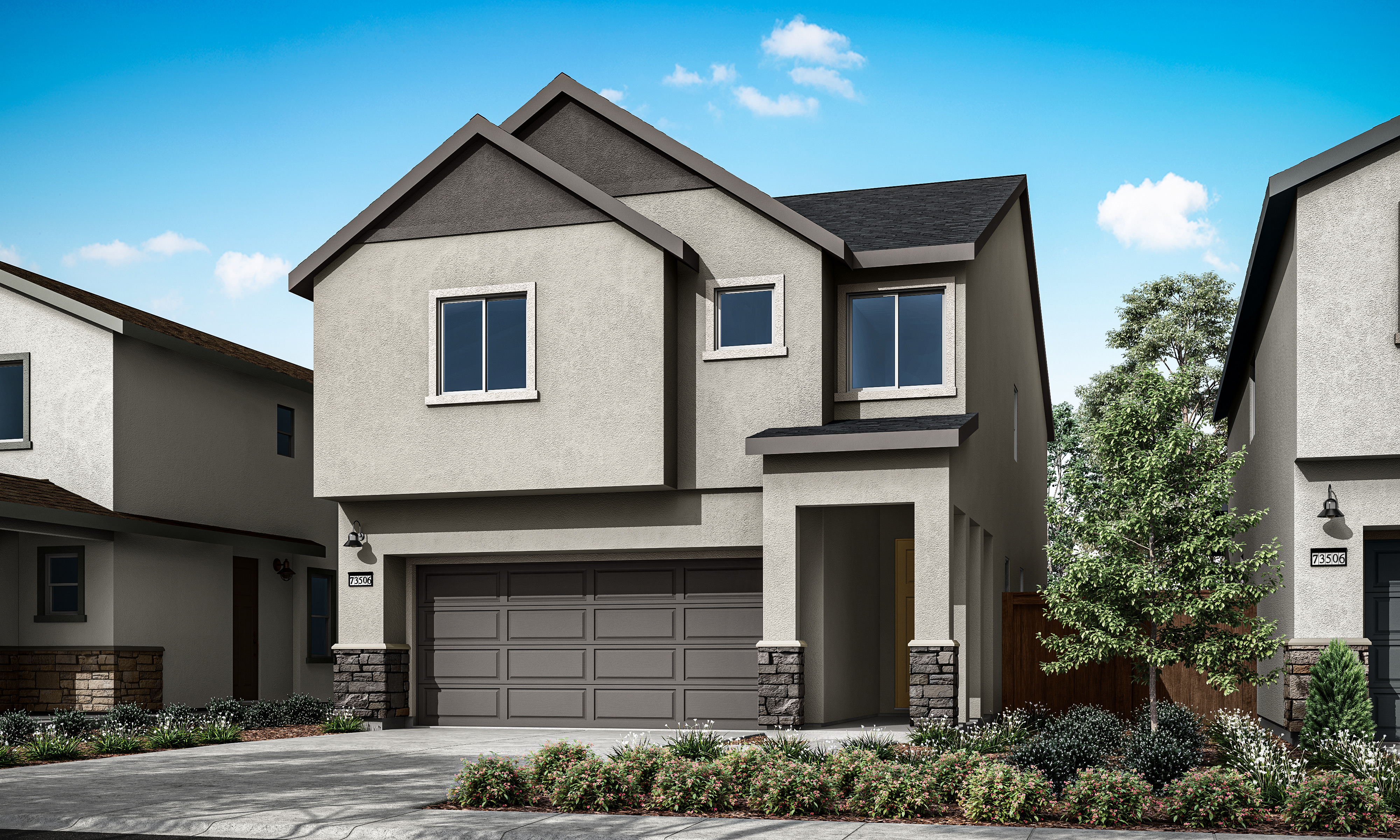 A two-story residential house with a gray exterior, a garage door, and a well-landscaped front yard set against a clear blue sky with scattered clouds.
