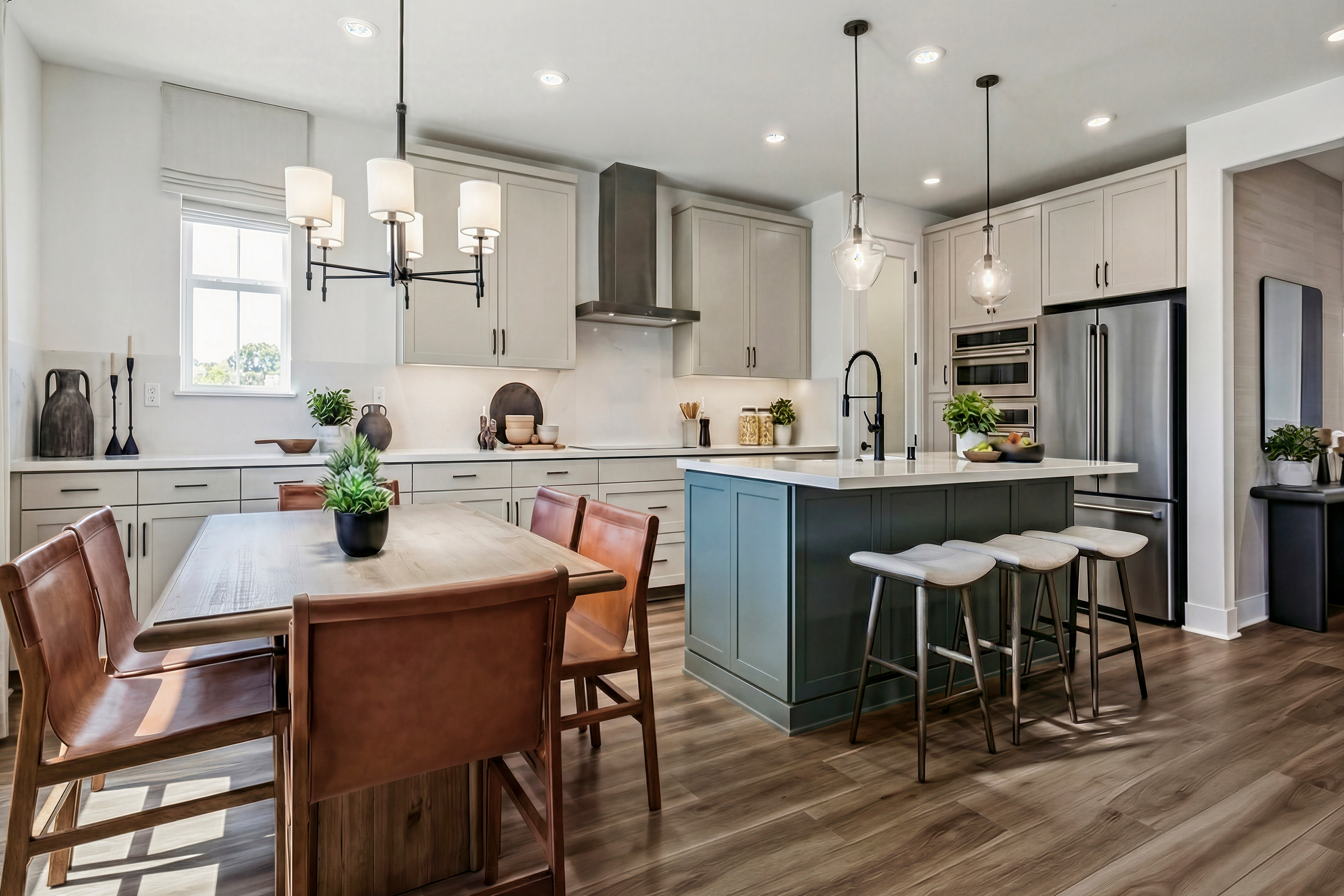 A modern and stylish kitchen with a wooden dining table, leather chairs, and a blue kitchen island with bar stools, complemented by pendant lighting and hardwood flooring.