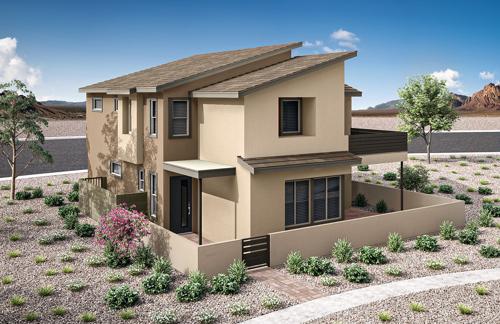 A modern tan house with a sloped roof sits in a landscaped yard with sparse desert vegetation, while a road and distant mountains are visible under a clear blue sky.
