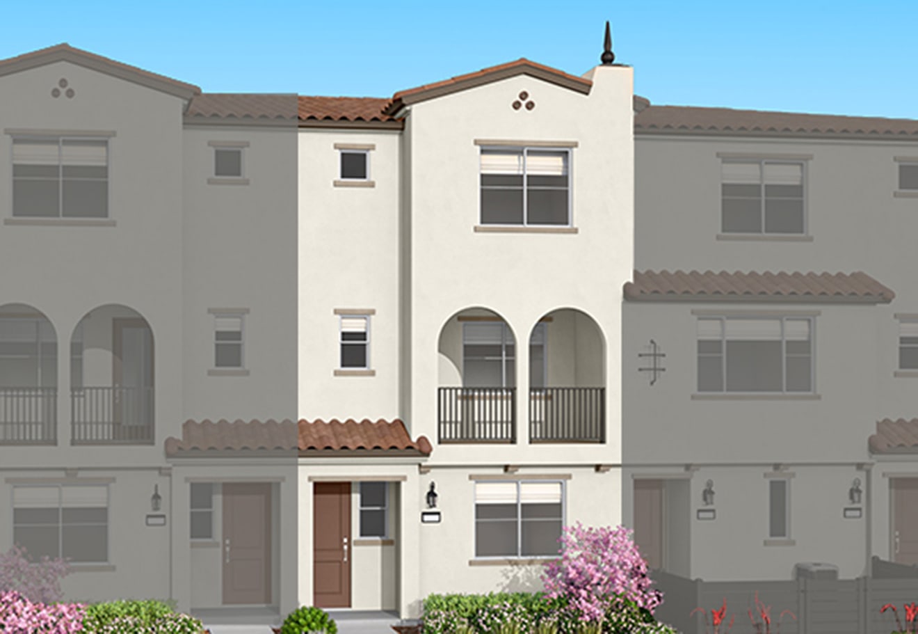 A cream-colored townhouse with a brown door and pink flowering bushes in the foreground is flanked by faded grey townhouses in the background.