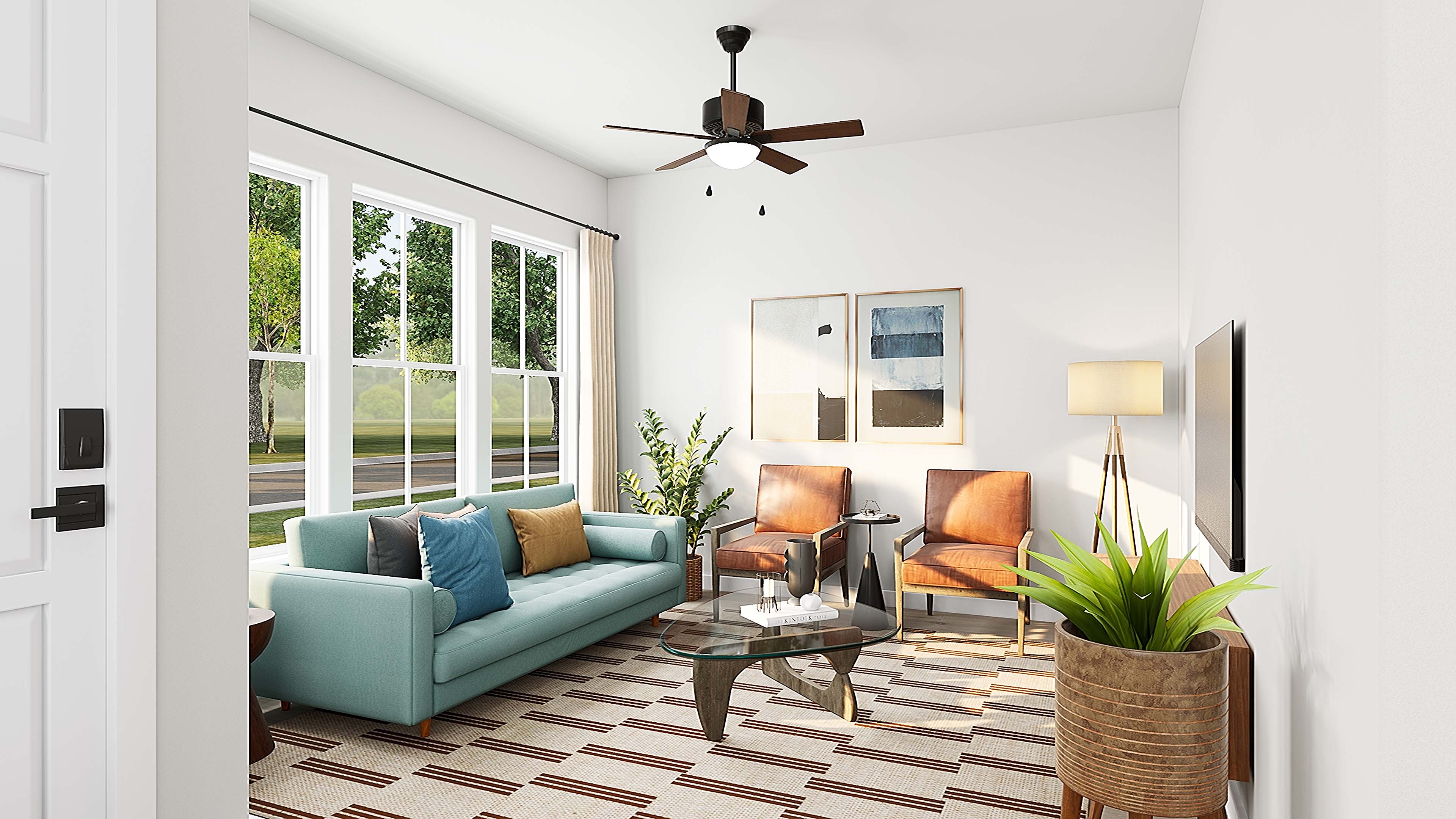 A modern living room with a teal sofa and coffee table in the foreground is set against a background of large windows overlooking greenery and artwork on the wall.