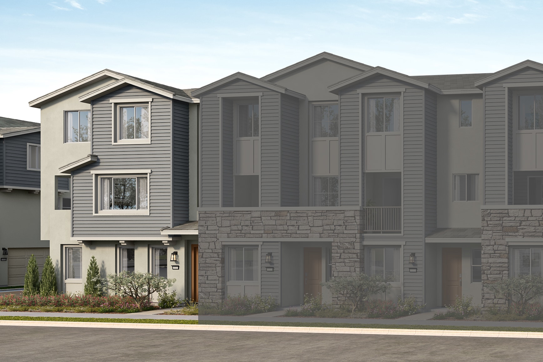 A row of modern townhouses with a light gray exterior and stone accents stands against a clear sky.