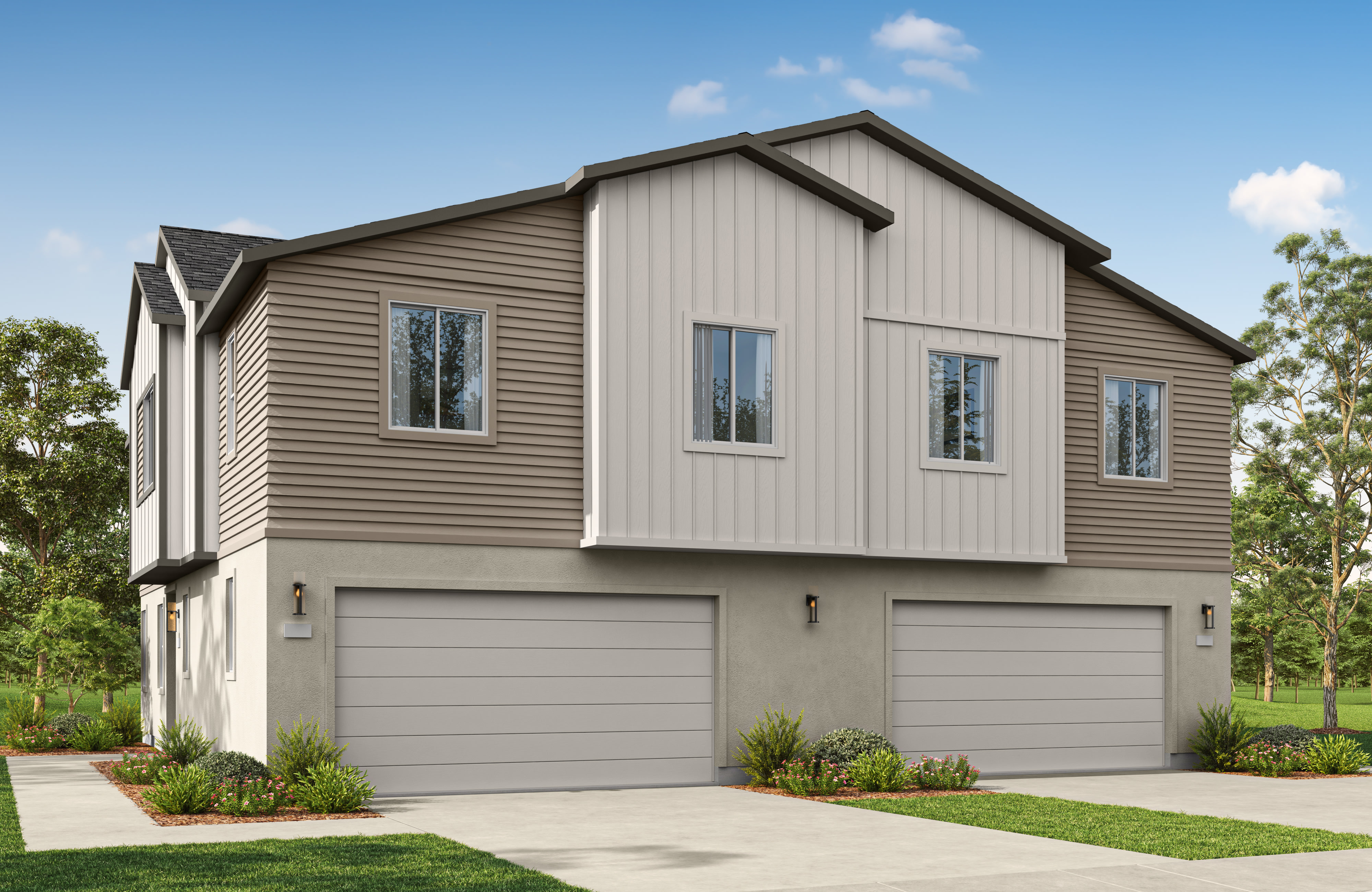 A modern two-story house with grey and white siding and two garage doors stands on a concrete driveway under a clear blue sky with scattered clouds.