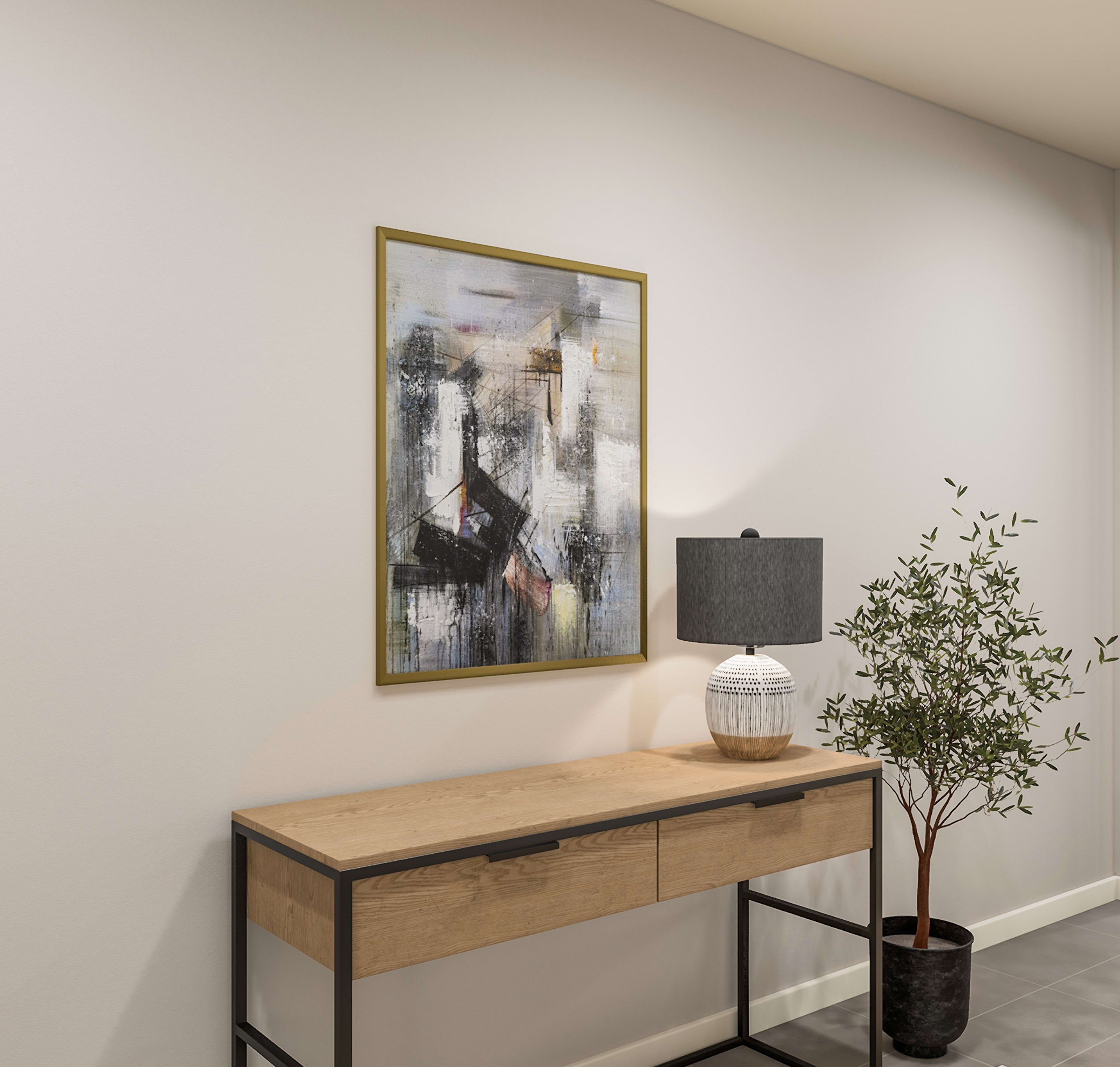 A modern console table with a lamp and artwork sits against a plain wall, with a potted plant to the right.