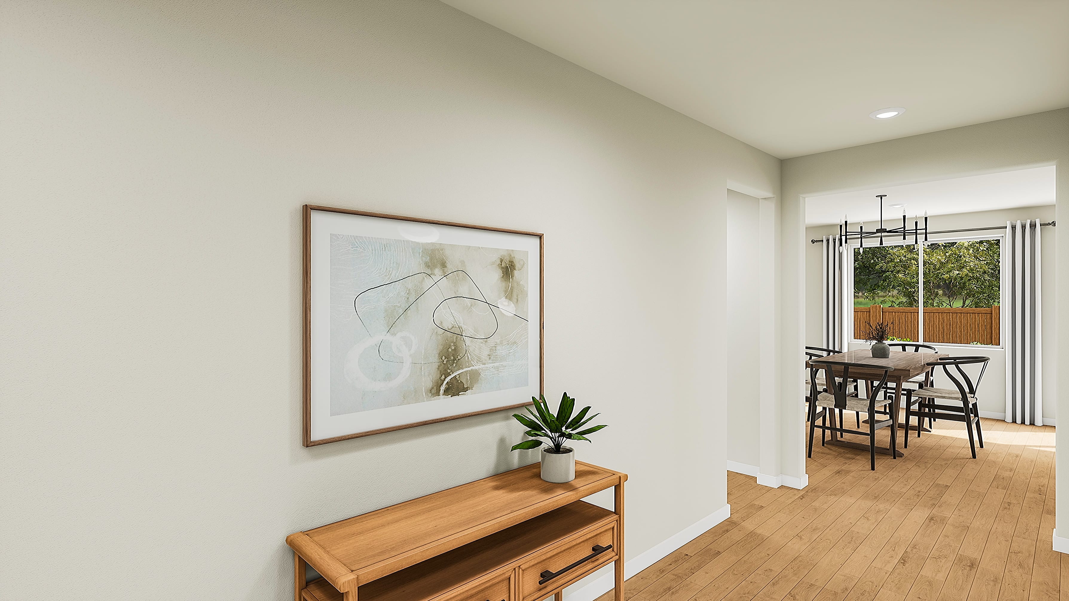 A framed abstract artwork hangs above a wooden console table with a potted plant in the foreground, while a dining room with a table and chairs is visible in the background.