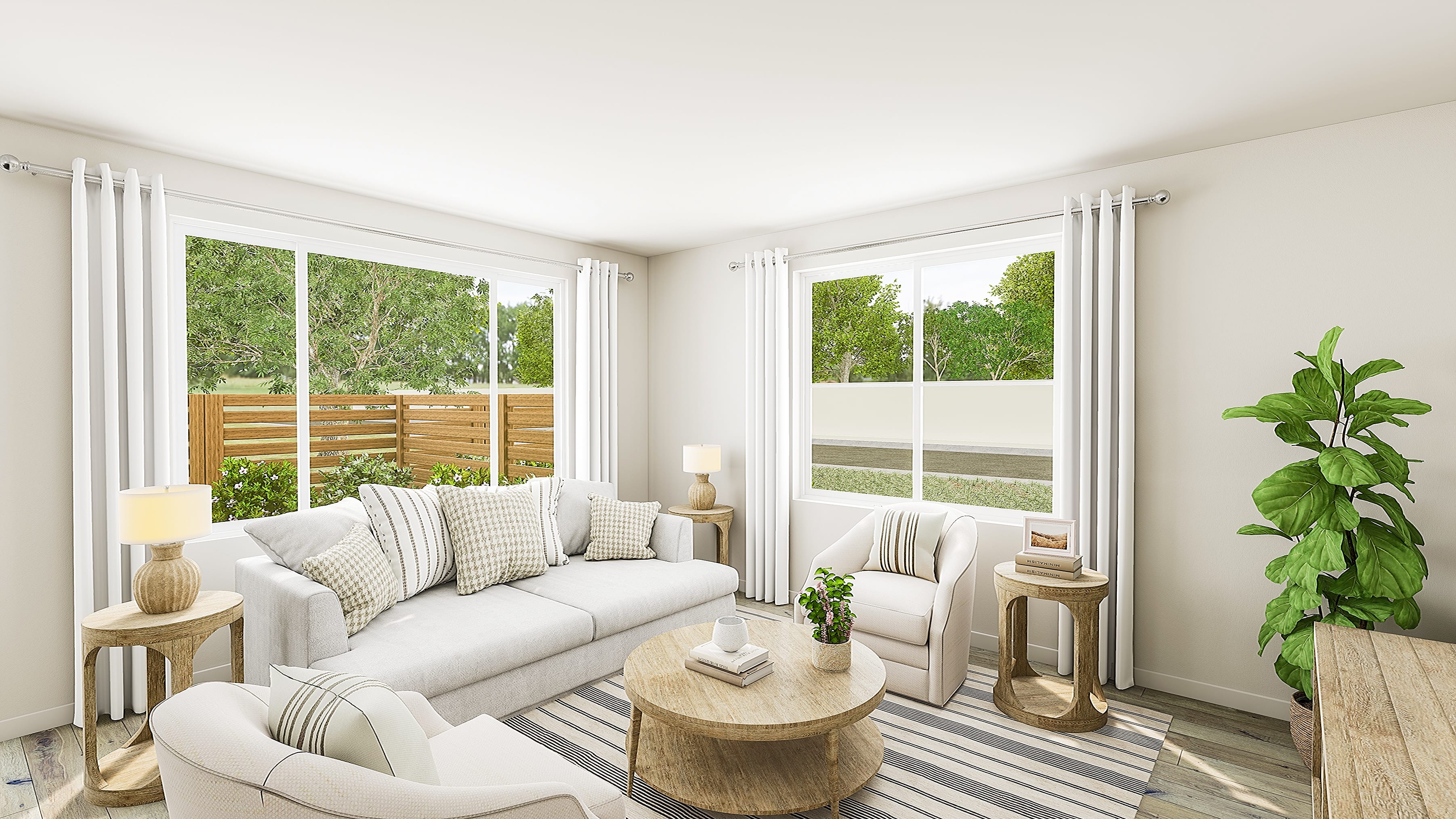 A bright living room with a white sofa and chairs in the foreground is illuminated by natural light streaming through large windows that reveal a backyard with a wooden fence and greenery in the background.