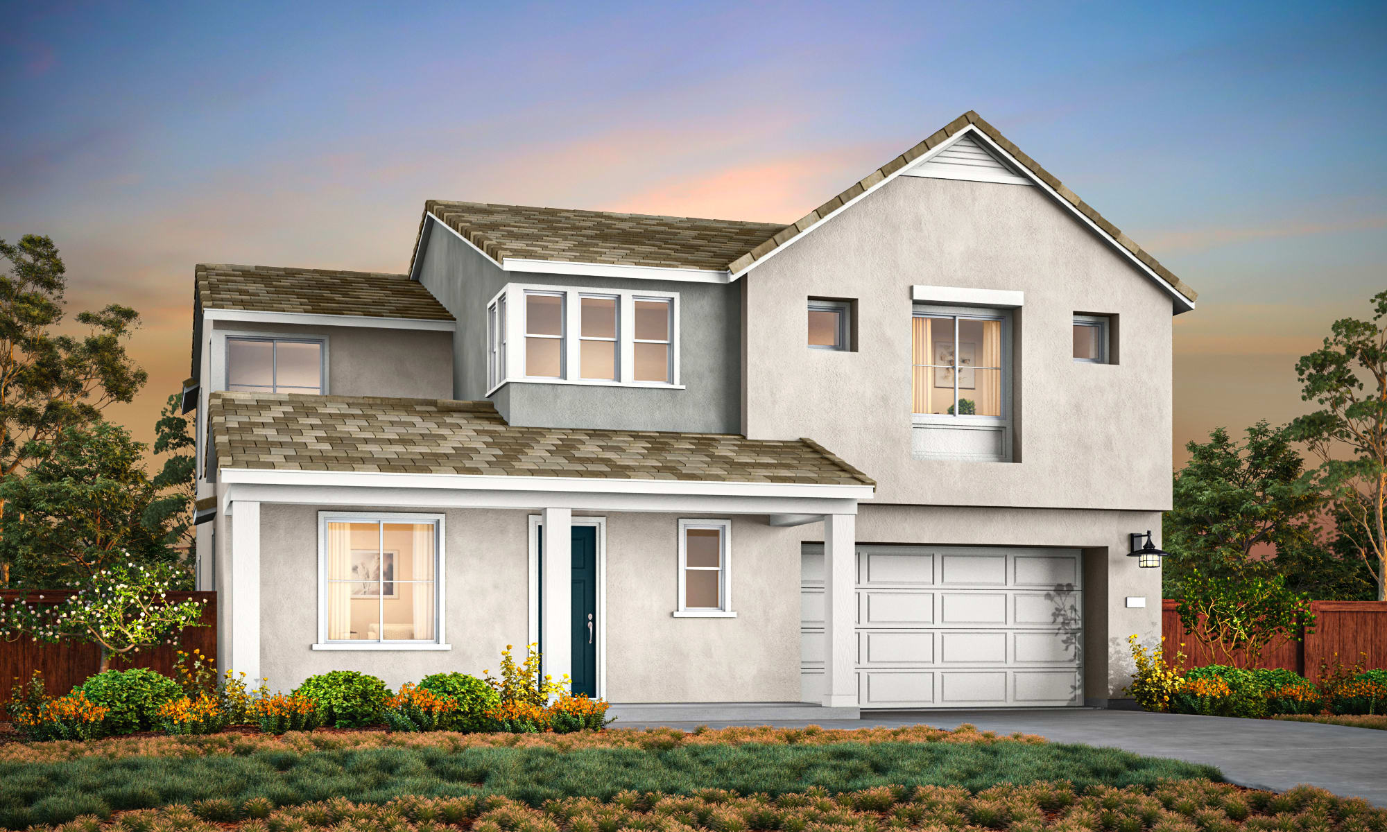 A two-story residential house with a garage, surrounded by a well-maintained garden and landscaping, set against a backdrop of a clear sky with a warm, colorful sunset.