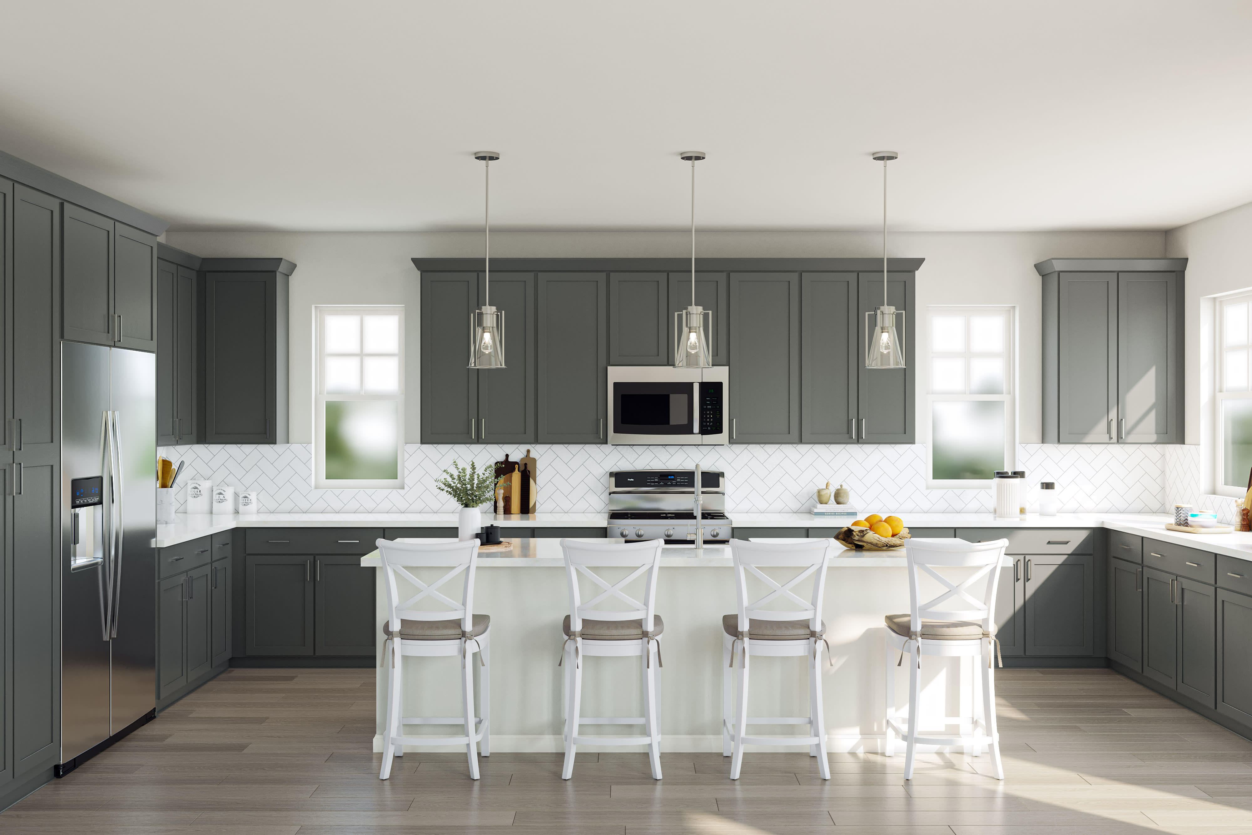 A modern, well-designed kitchen with gray cabinets, white countertops, and pendant lighting over a central island with stools.