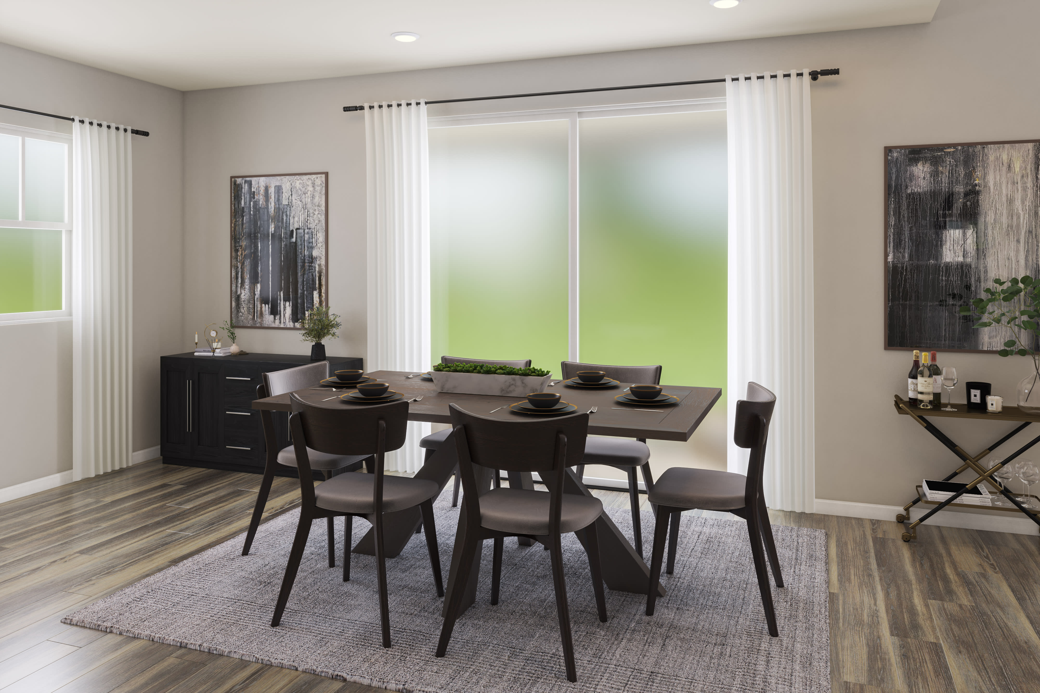 A modern and minimalist dining room with a wooden table, dark chairs, and abstract artwork on the walls, set against a backdrop of large windows overlooking a lush green outdoor space.