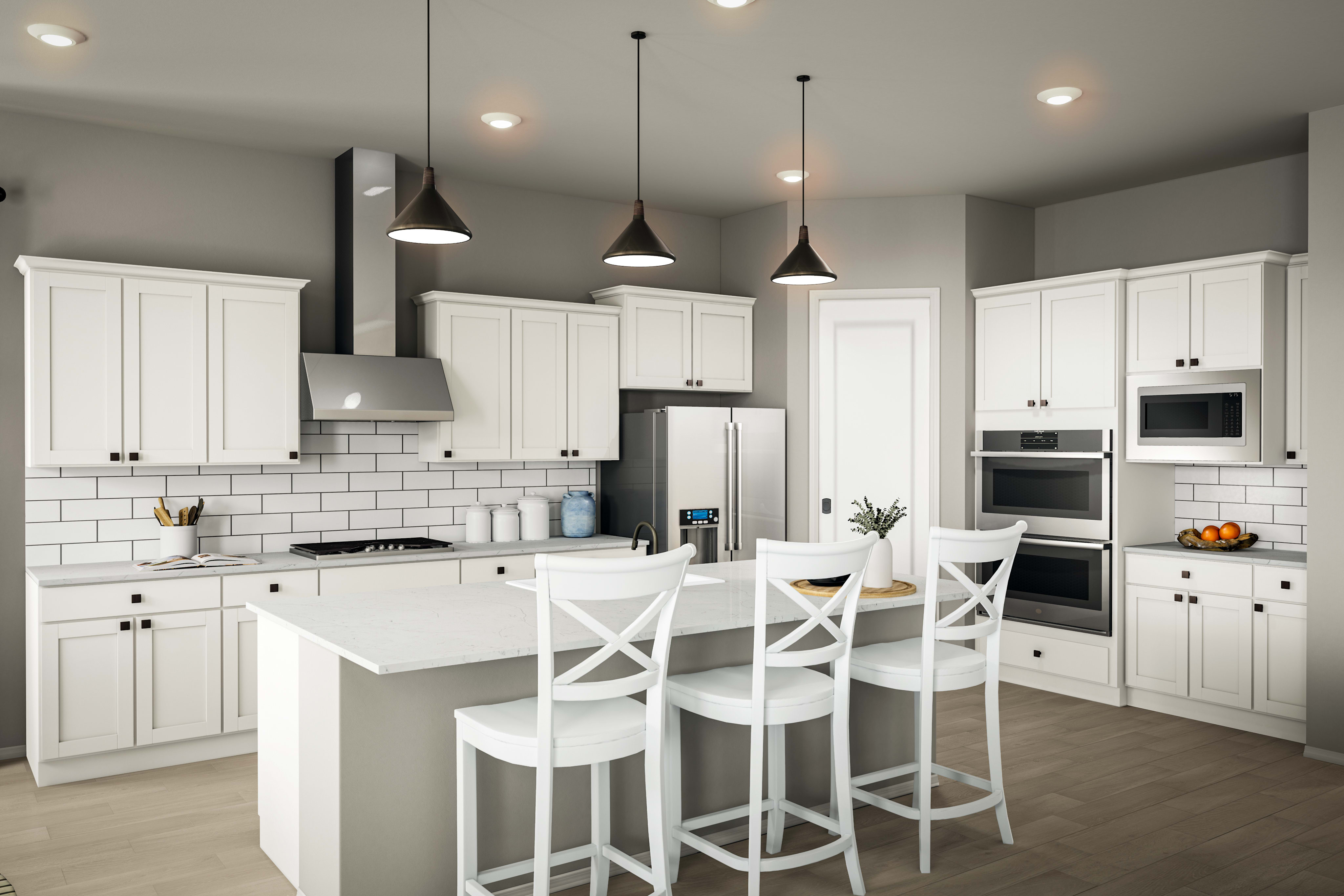 A modern, well-lit kitchen with white cabinets, a white countertop, and pendant lights hanging above a central island with bar stools.