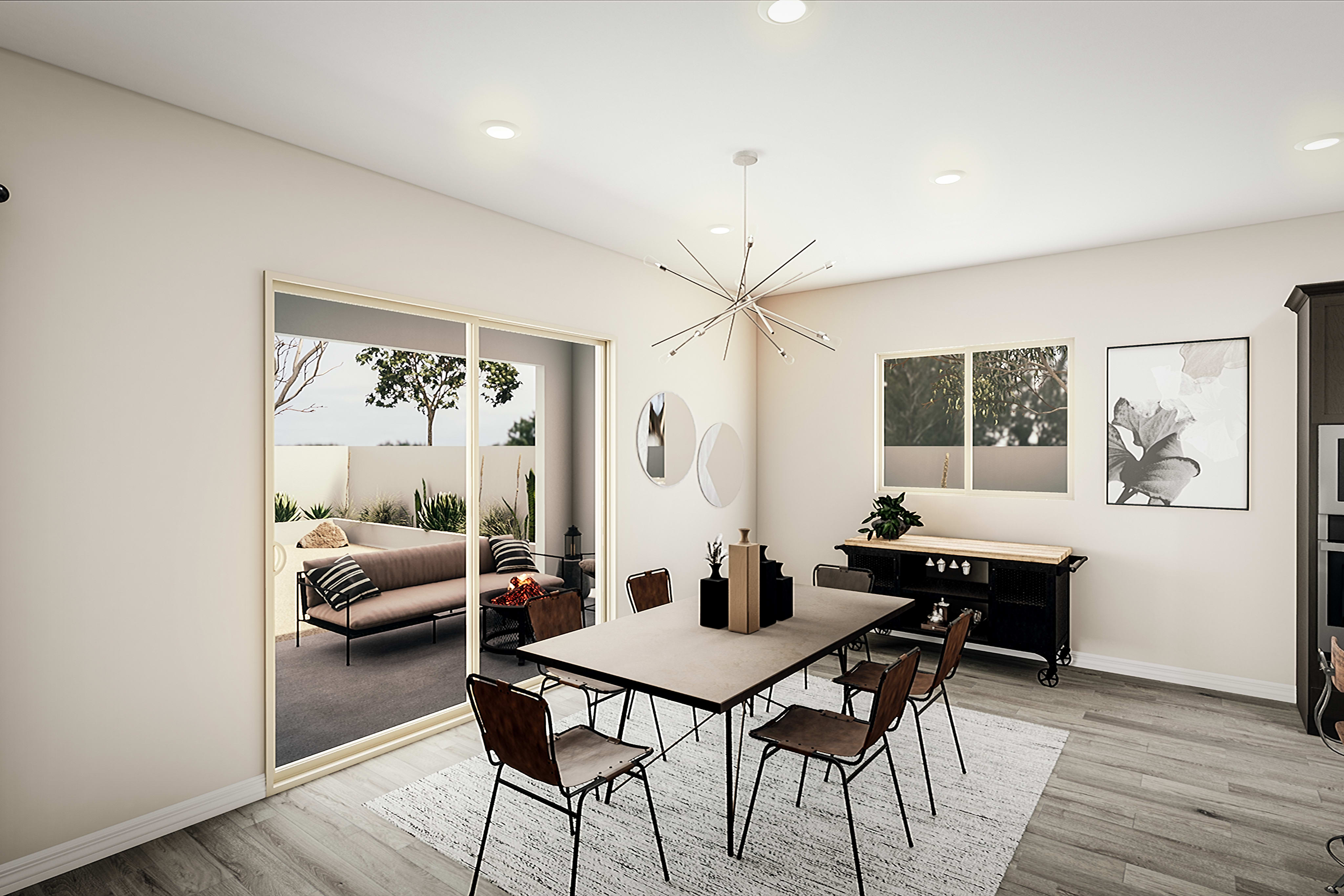 A modern and minimalist dining area with a wooden table, metal chairs, and various decorative elements, including artwork and a chandelier, in a bright and airy room.