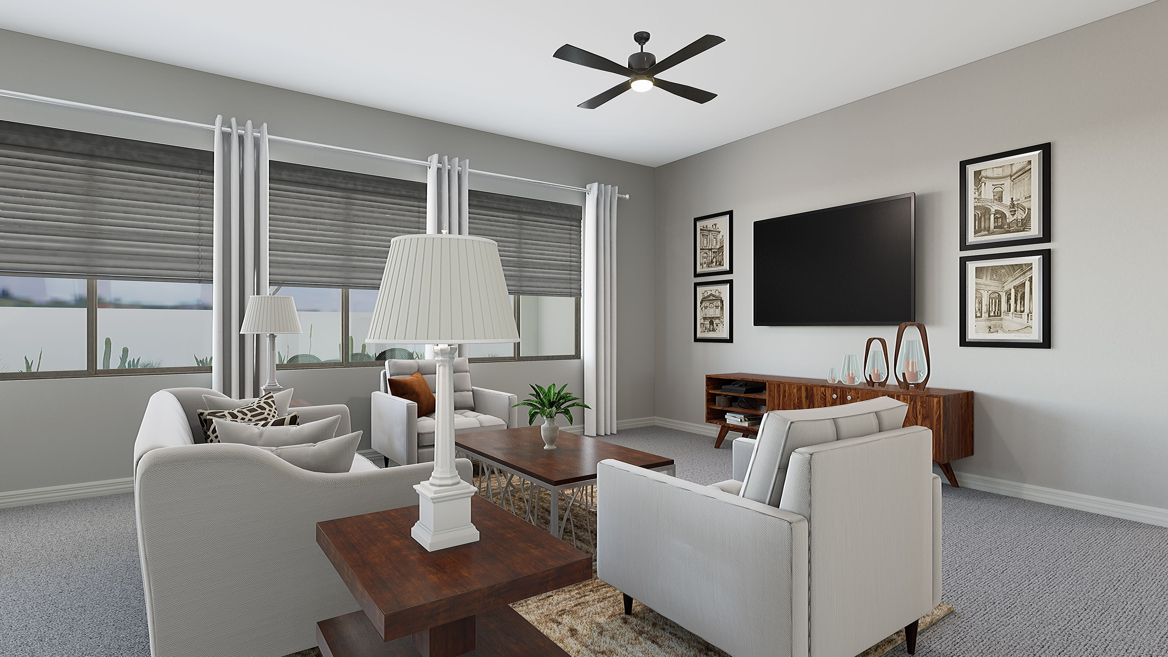 A cozy living room with white furniture, a TV mounted on the wall, and framed artwork decorating the space, set against a backdrop of large windows overlooking a scenic outdoor view.