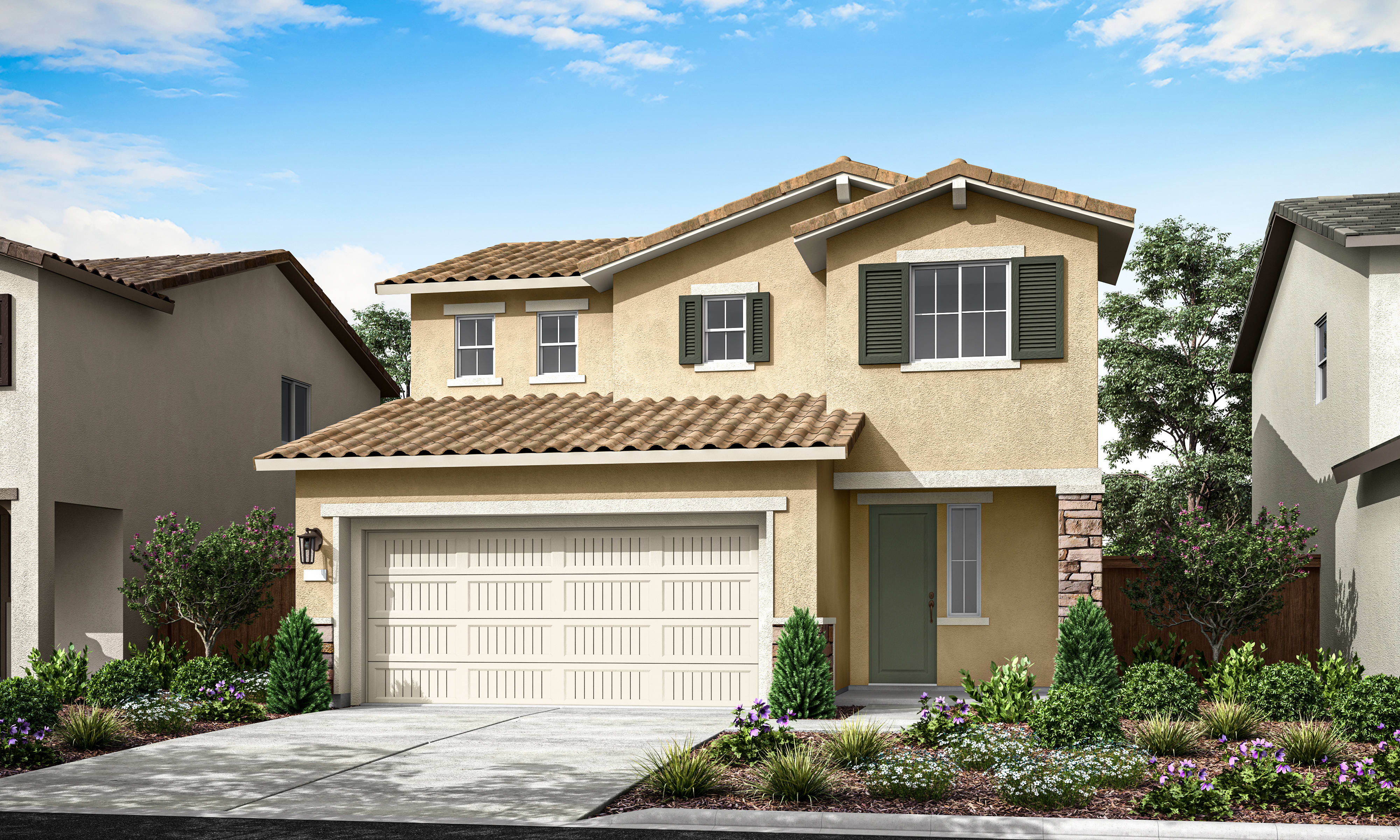 A two-story beige house with a tiled roof, a garage door, and a well-landscaped front yard with shrubs and flowers, set against a blue sky with scattered clouds.