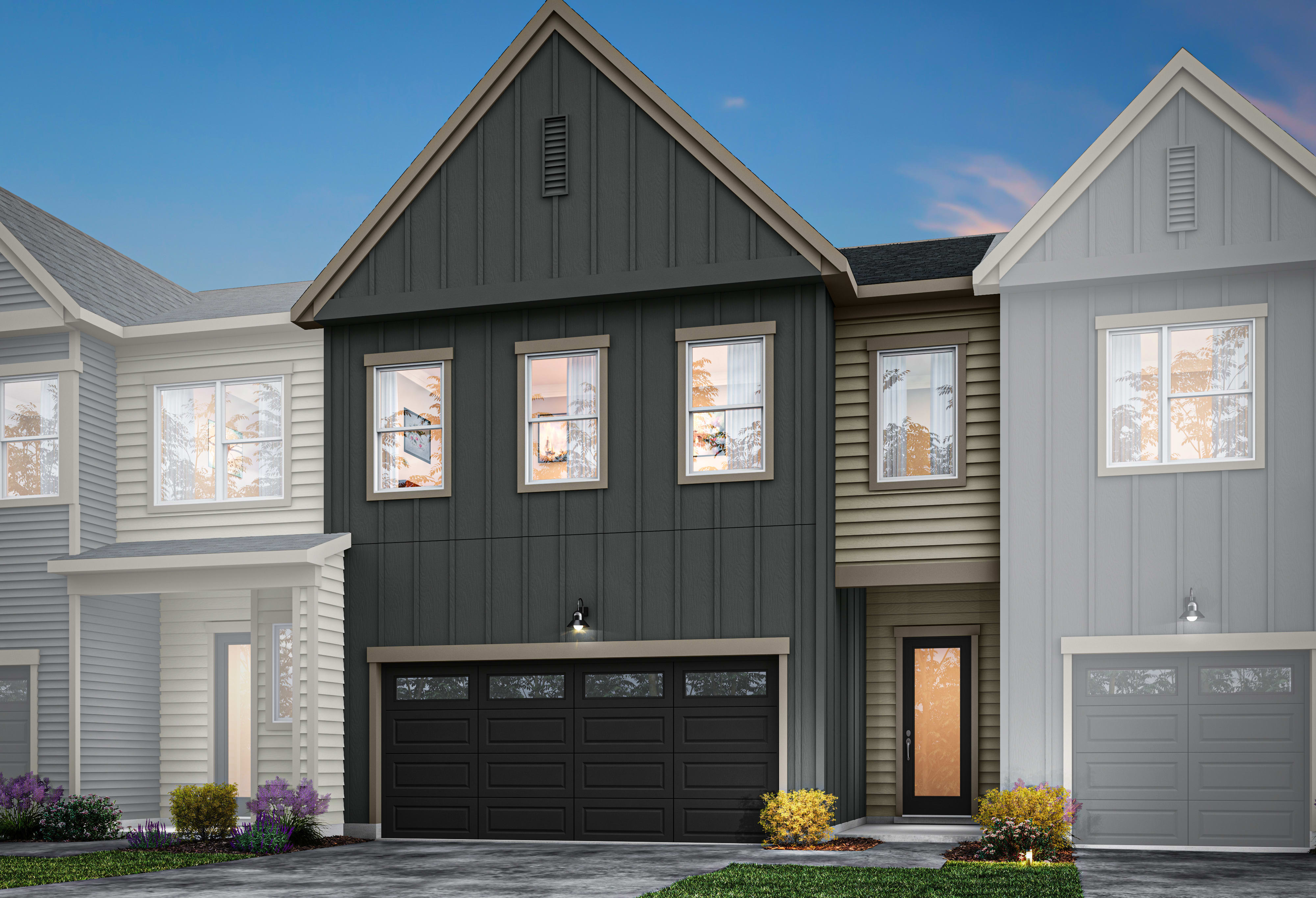 A modern two-story house with a black garage door, gray siding, and a triangular roof peak stands in the foreground, surrounded by a paved driveway and landscaped greenery.