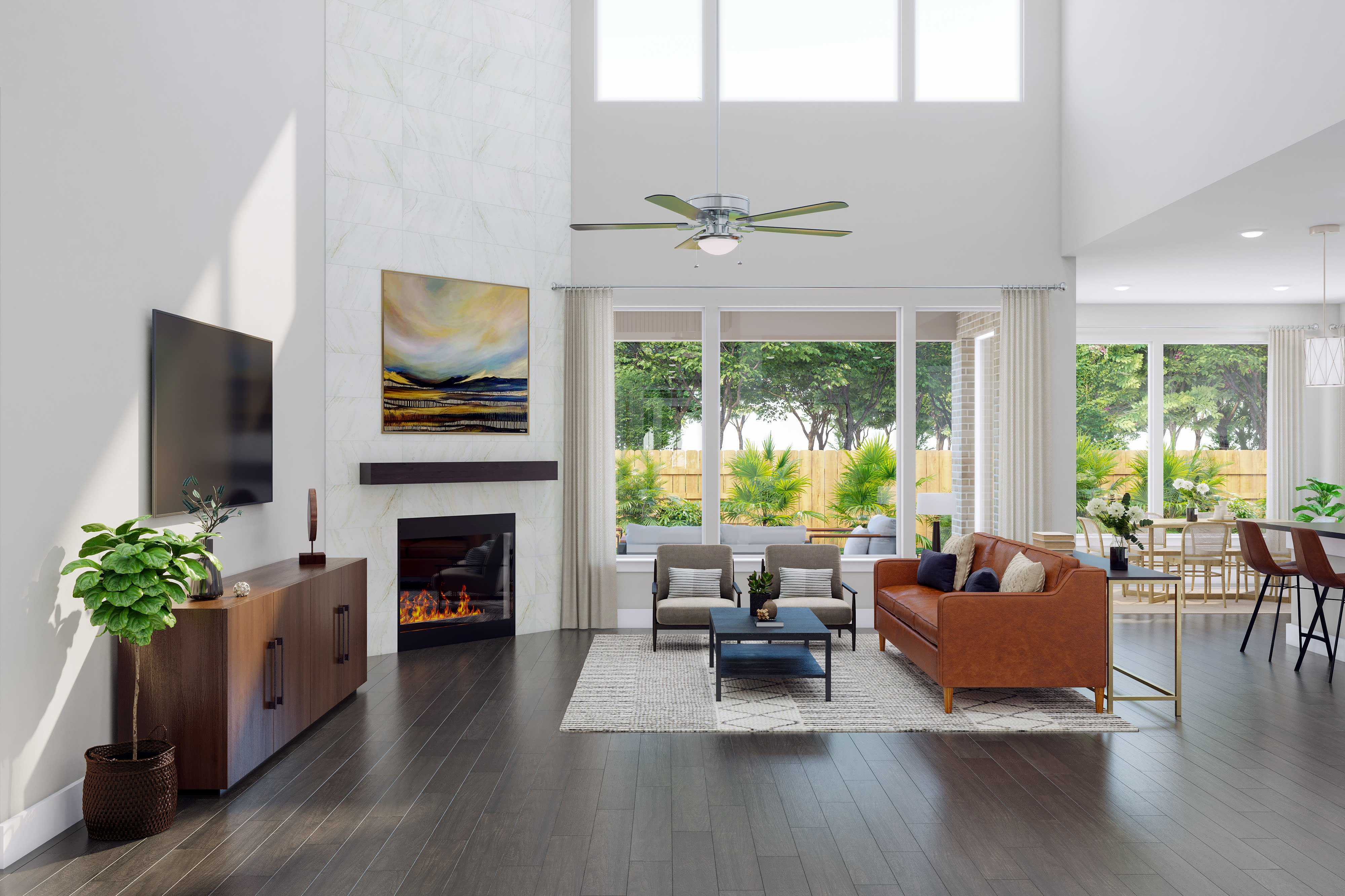 A spacious and well-lit living room with a fireplace, comfortable furniture, and large windows overlooking a lush outdoor landscape.