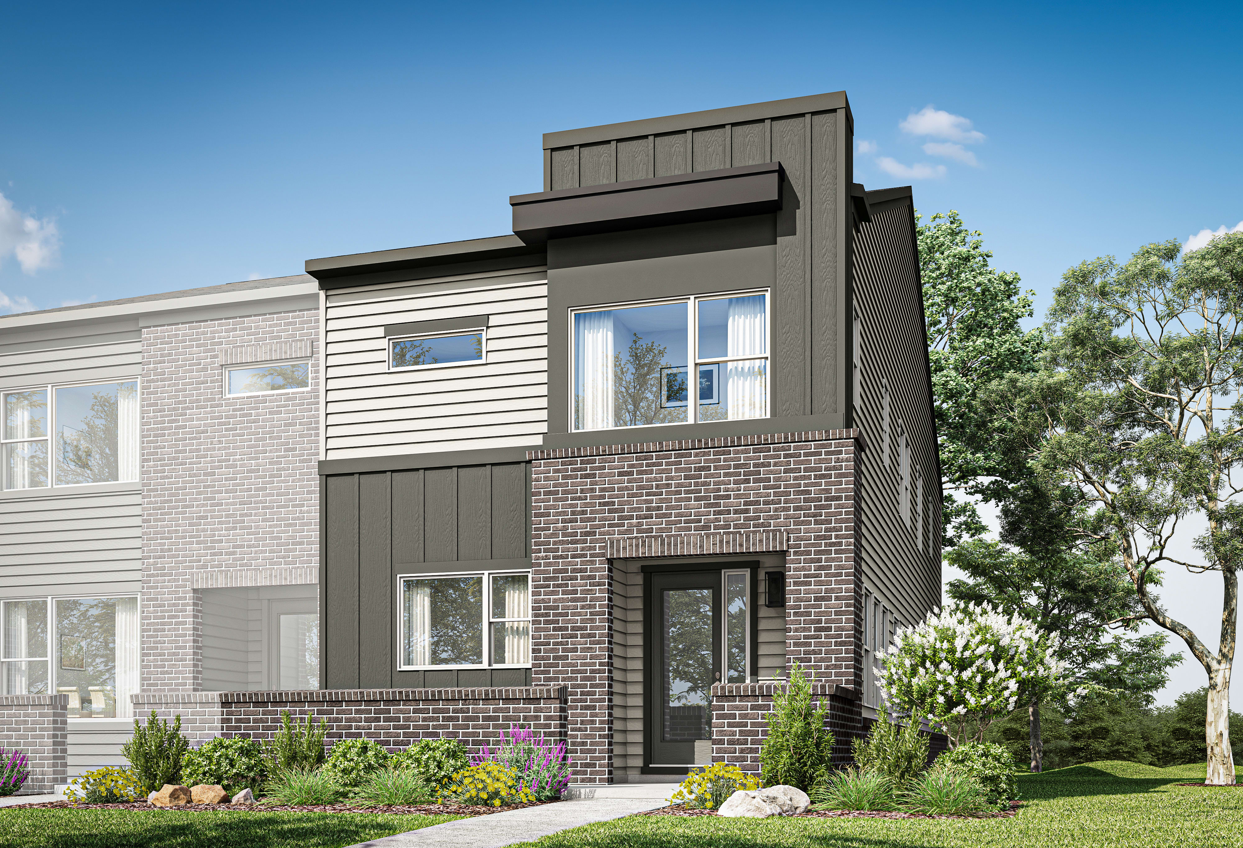 A modern two-story townhouse with a brick and siding exterior, surrounded by lush greenery and a well-manicured lawn in the foreground.