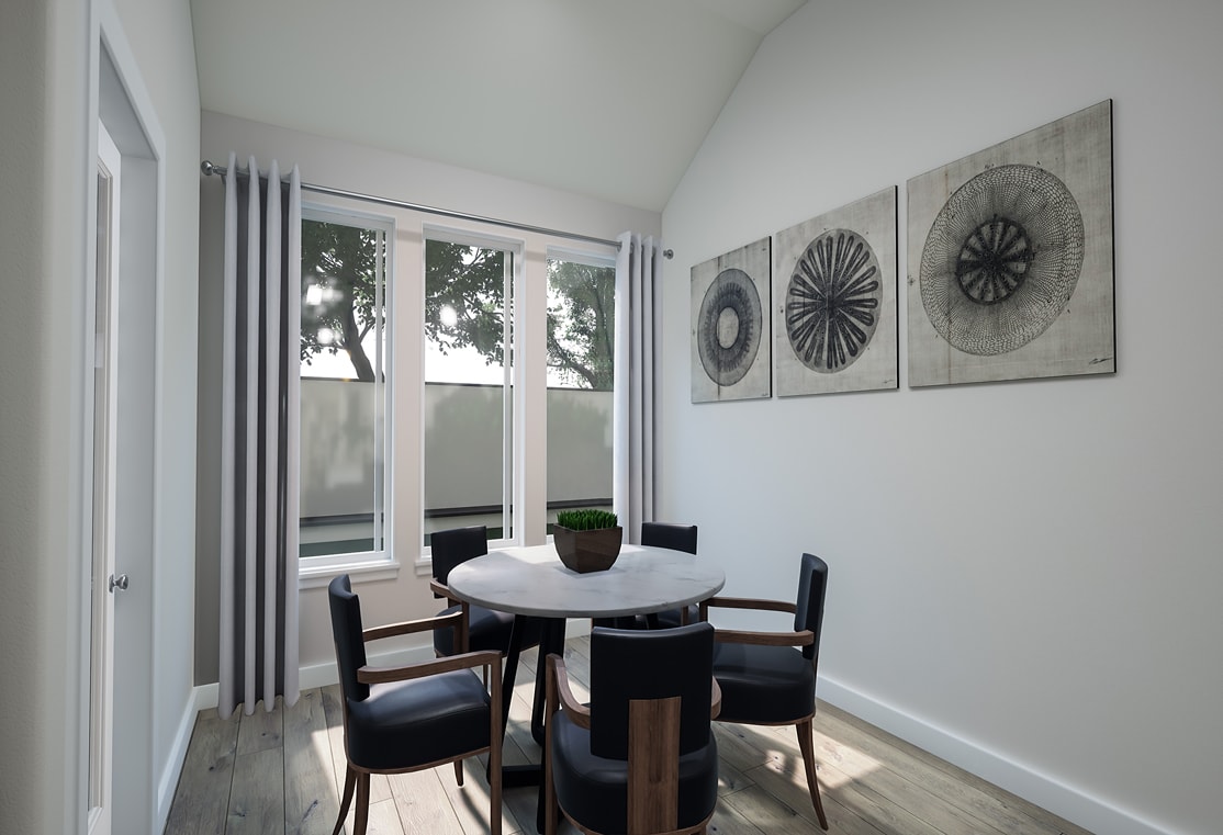 A modern and minimalist dining area with a round white table, black chairs, and decorative wall art featuring circular patterns in shades of gray.