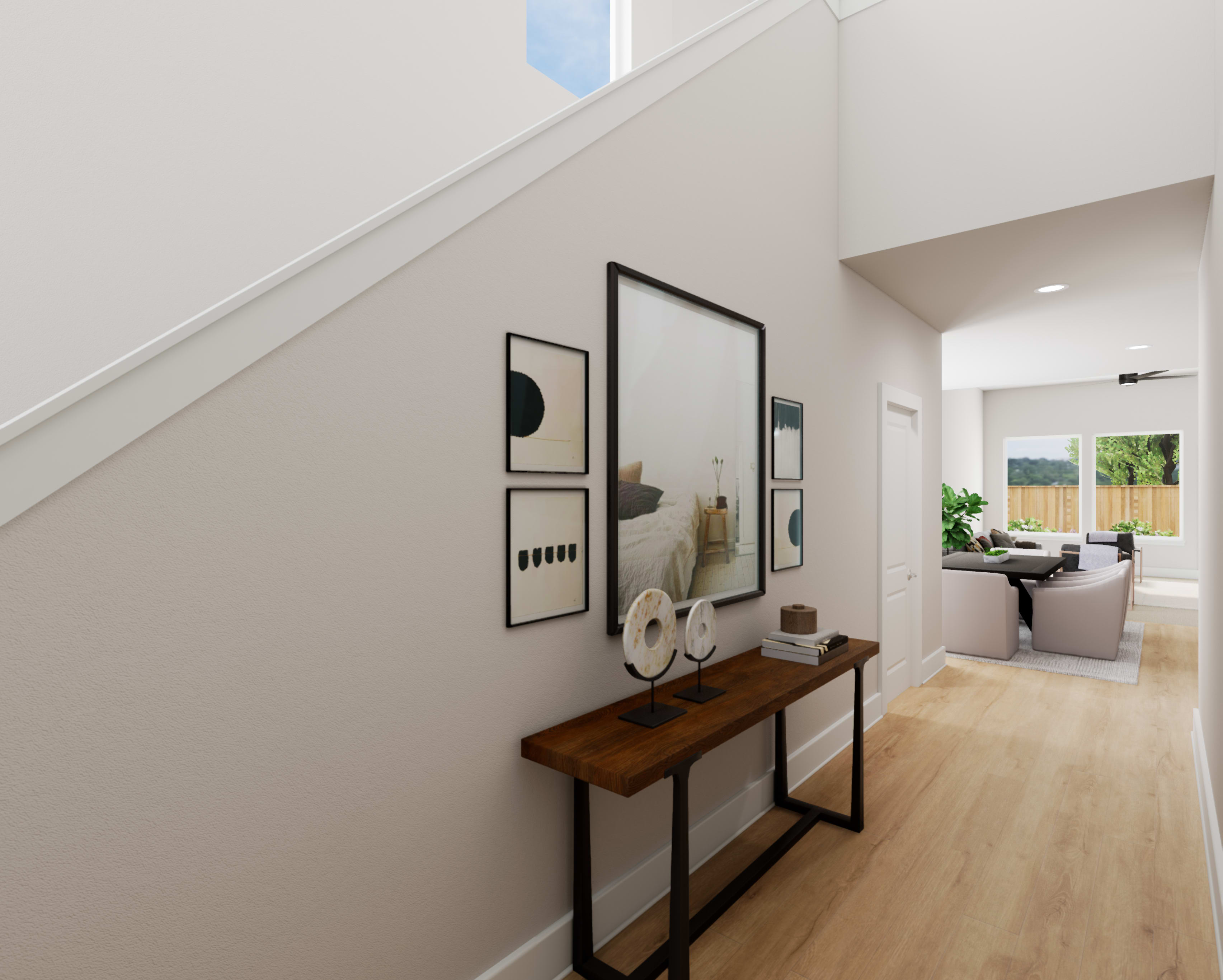 A modern and minimalist entryway with a wooden console table, framed artwork, and a view of an adjacent room with natural lighting.