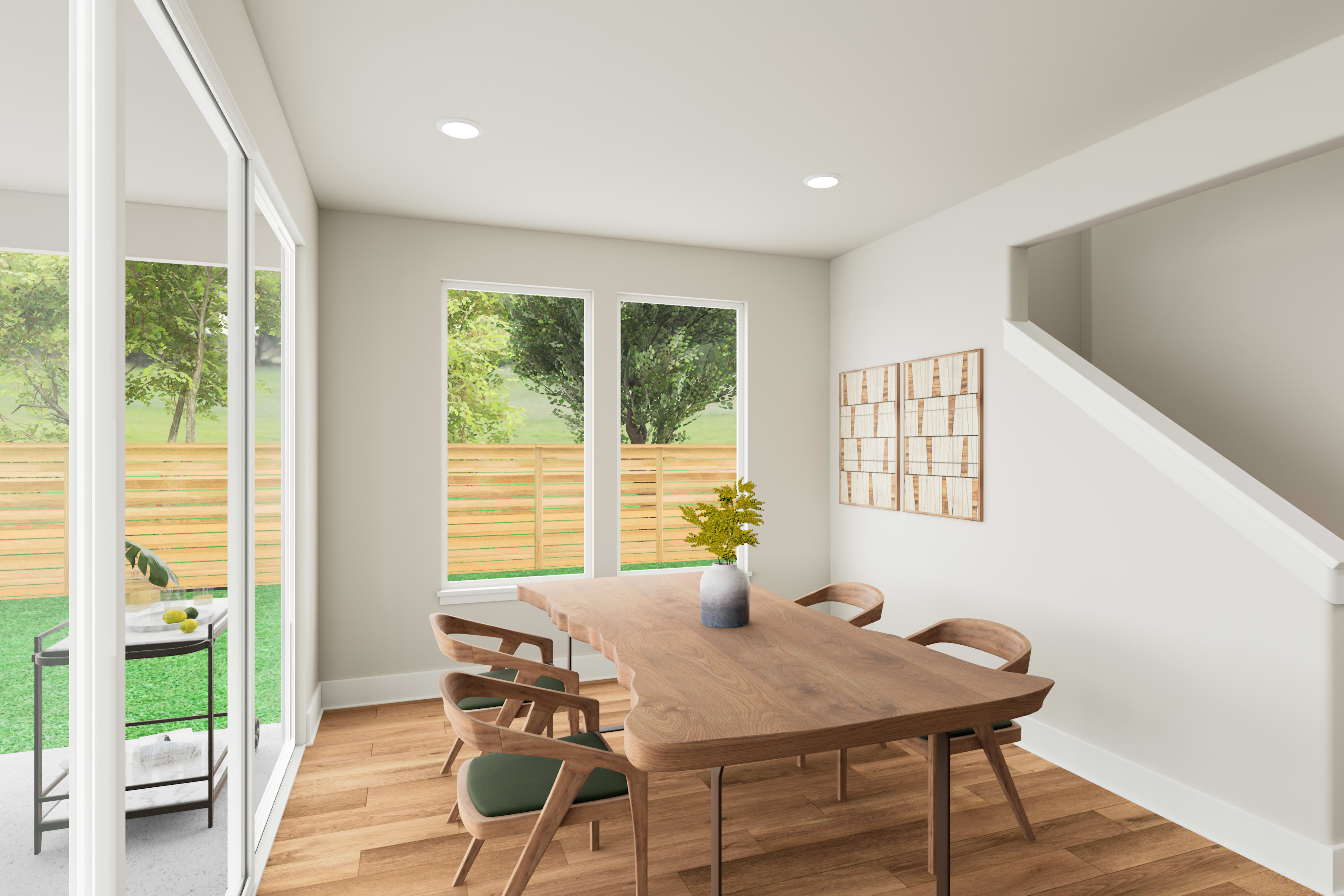 A modern and minimalist dining area with a wooden table and chairs, surrounded by large windows overlooking a lush, green backyard.